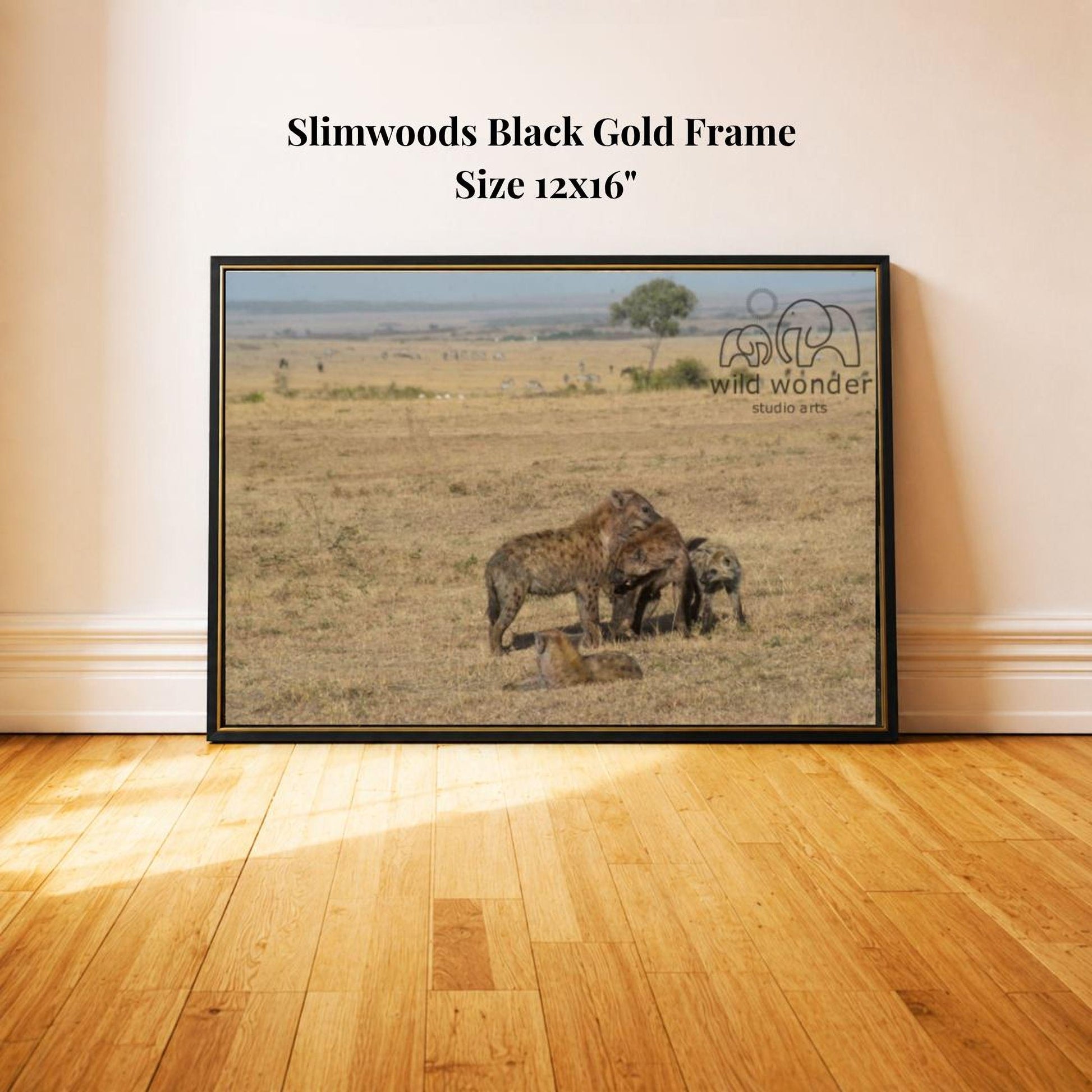 A framed photograph of a wild animal, likely a large feline, standing in a grassy field with a tree in the background.