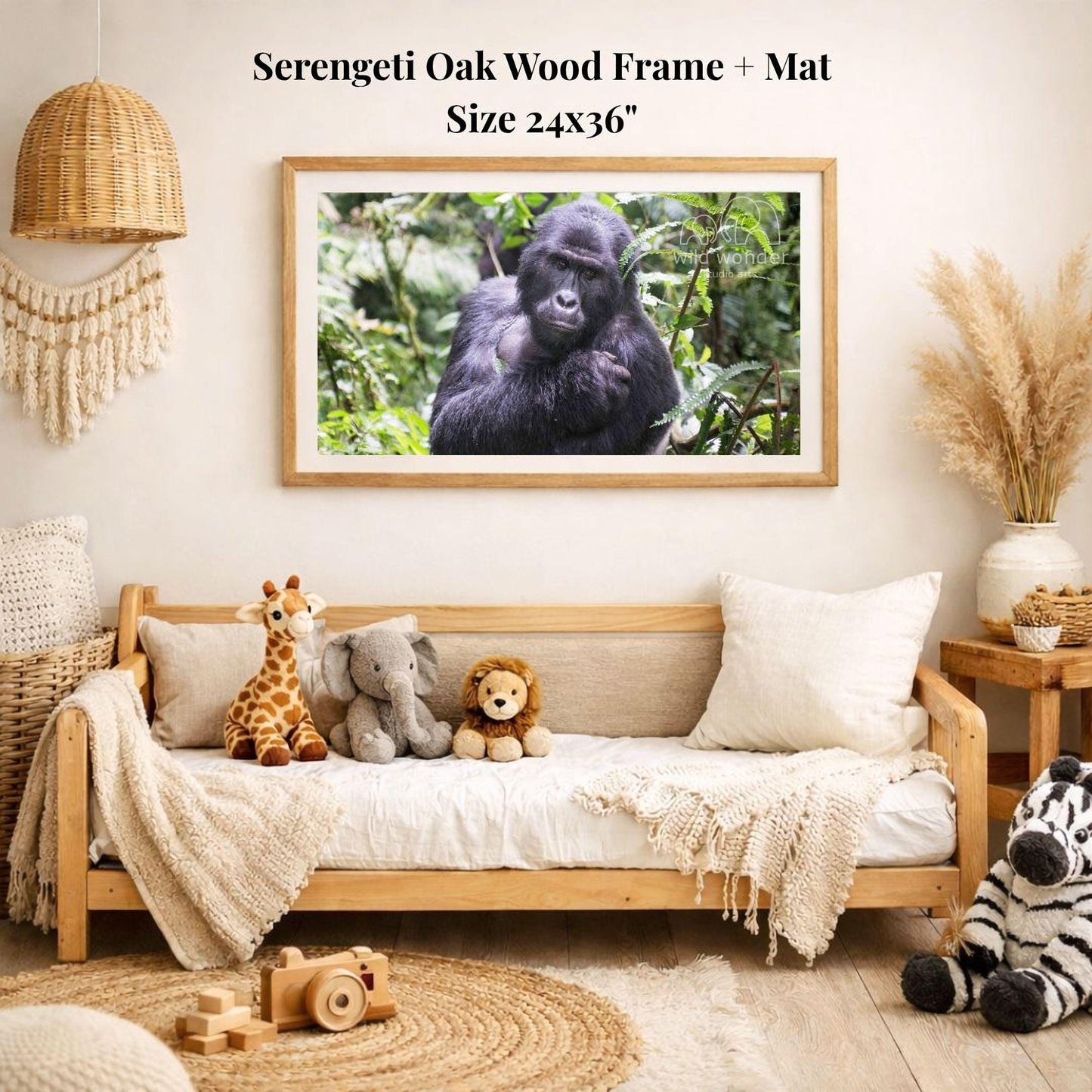 a serene indoor setting with a wooden frame and mat hanging on the wall, displaying a photograph of a gorilla in a lush forest. The room is decorated with various stuffed animals, including a giraffe, elephant, lion, and zebra, arranged on a couch and a rug.