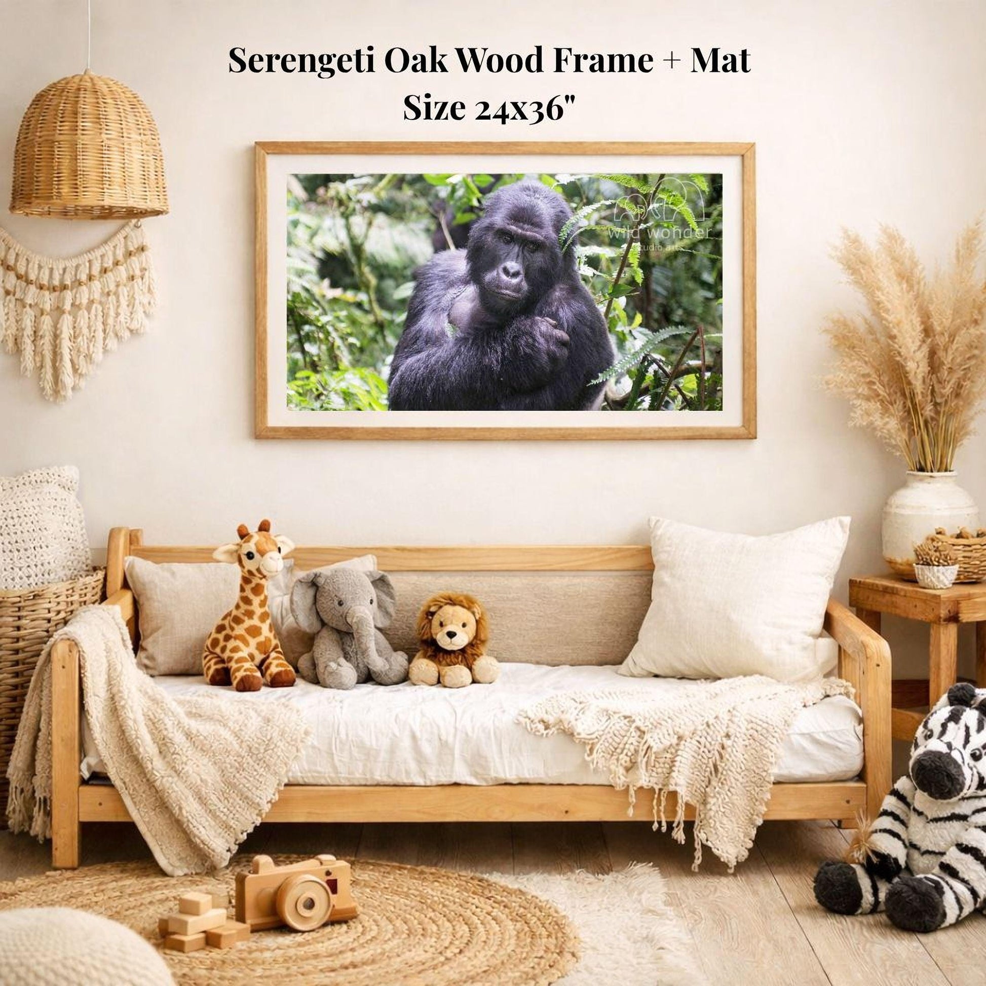 a serene indoor setting with a wooden frame and mat hanging on the wall, displaying a photograph of a gorilla in a lush forest. The room is decorated with various stuffed animals, including a giraffe, elephant, lion, and zebra, arranged on a couch and a rug.
