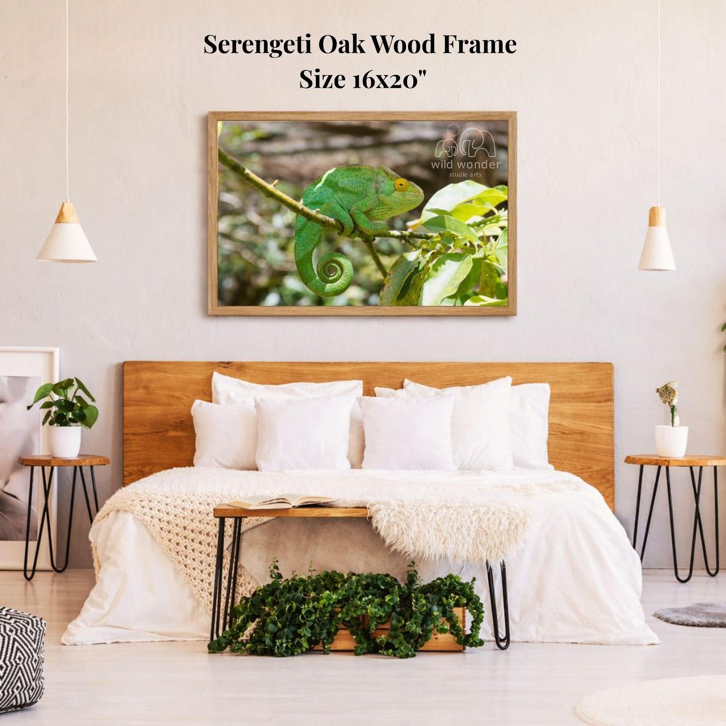 a serene bedroom scene with a large framed photograph of a green chameleon perched on a branch hanging above a bed with white bedding. The room has a wooden headboard, a nightstand on each side of the bed, and a potted plant on the floor. The overall atmosphere is calm and natural, with the chameleon as the focal point.