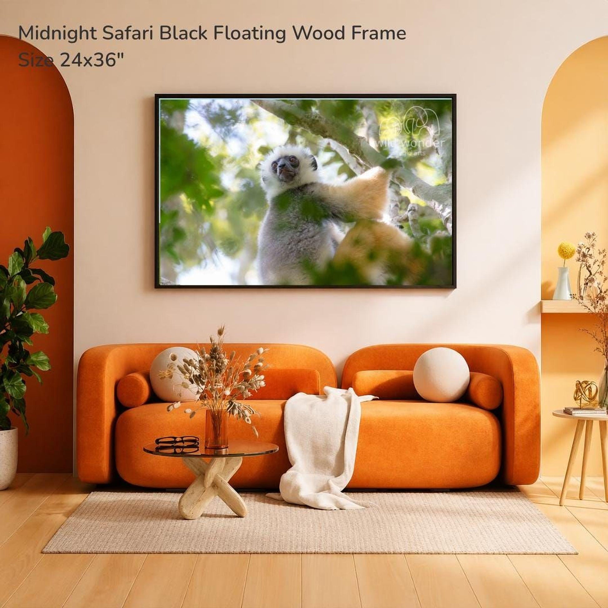 a cozy living room with an orange sofa, a glass coffee table, and a framed photograph of a lemur hanging on the wall.