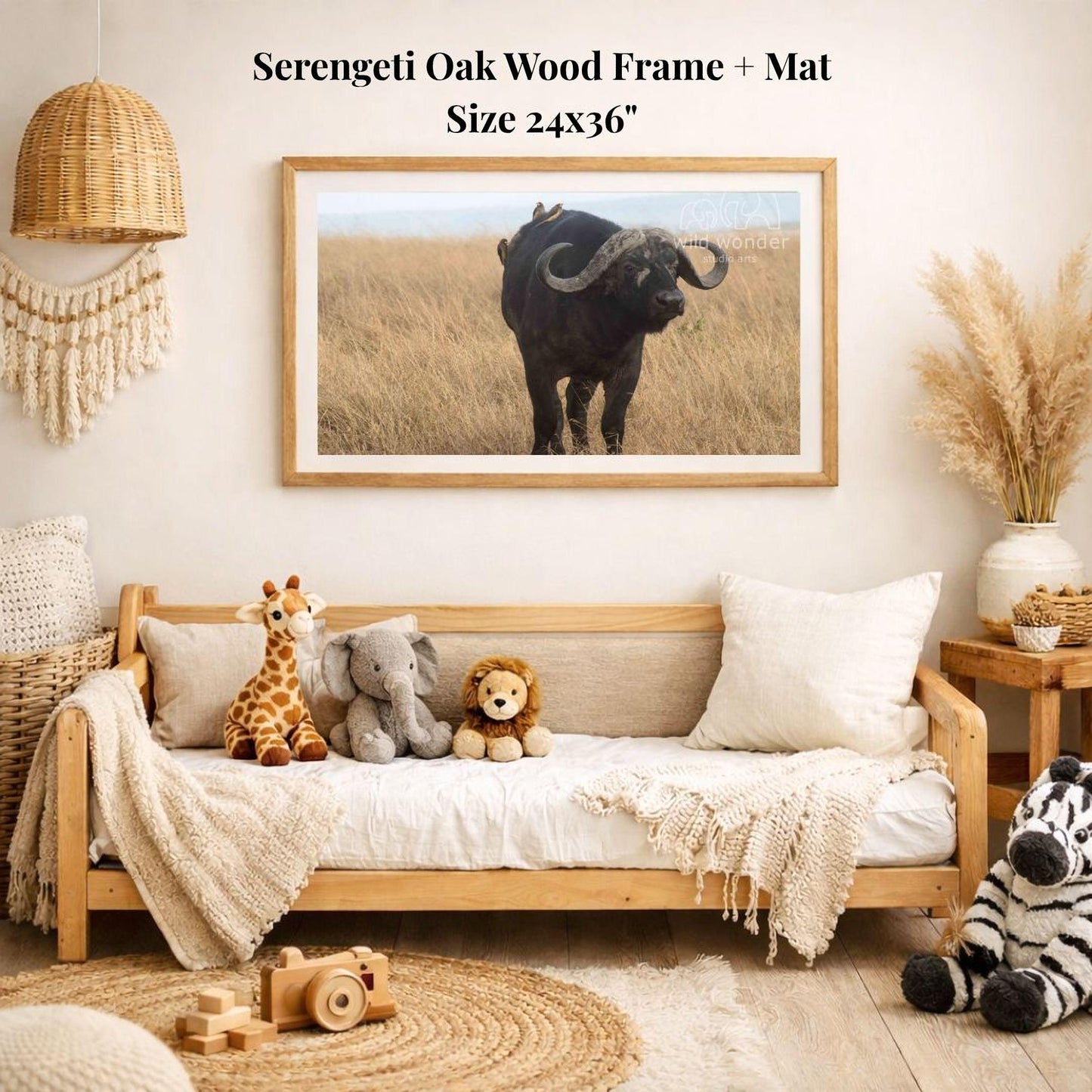 a serene indoor setting with a wooden frame and mat hanging on the wall, displaying a photograph of a serene scene of a horned animal in a field. The frame is surrounded by various stuffed animals, including a giraffe, elephant, lion, and zebra, creating a cozy and playful atmosphere.