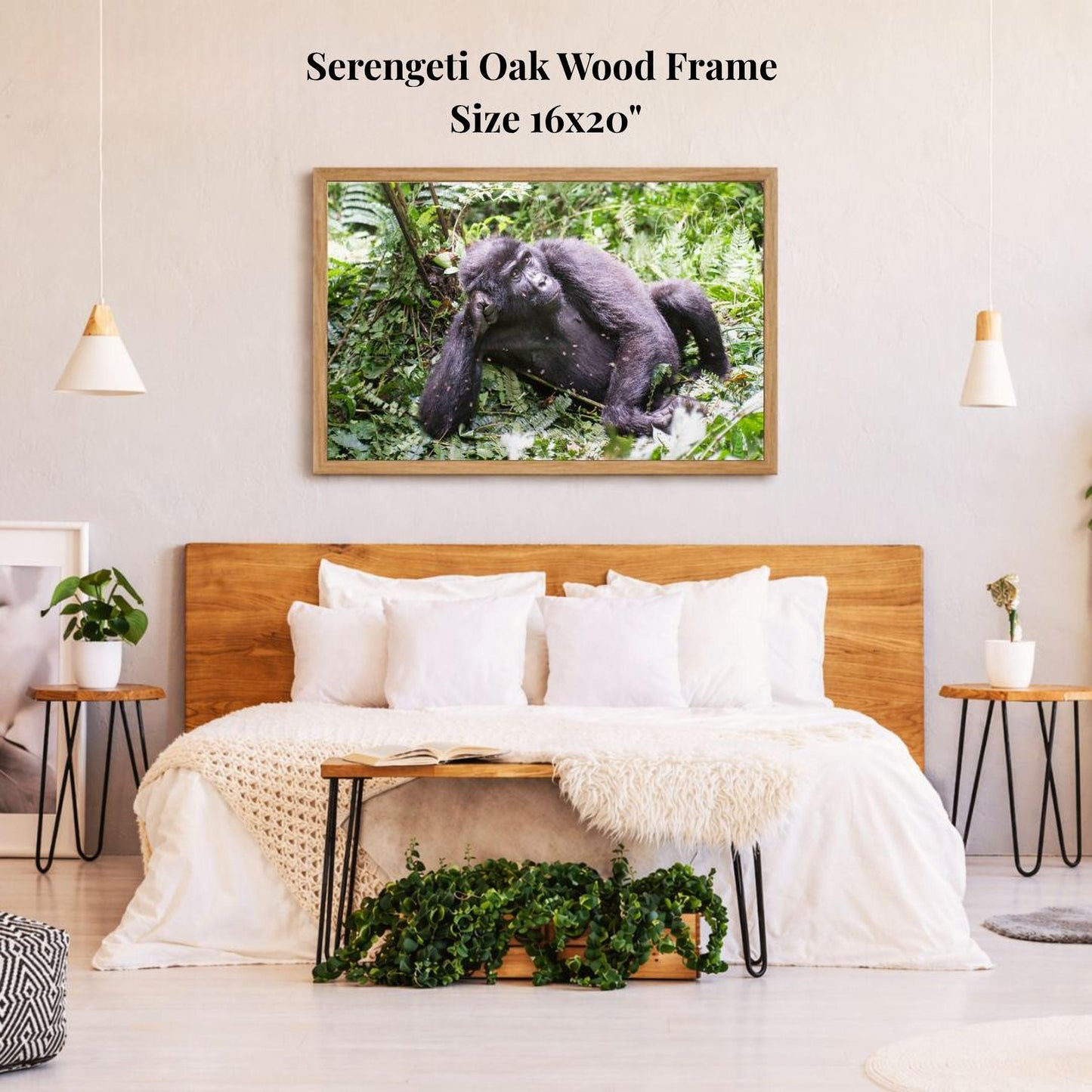 a serene bedroom scene with a large framed photograph of a gorilla resting on a tree branch hanging on the wall above a bed with white bedding.