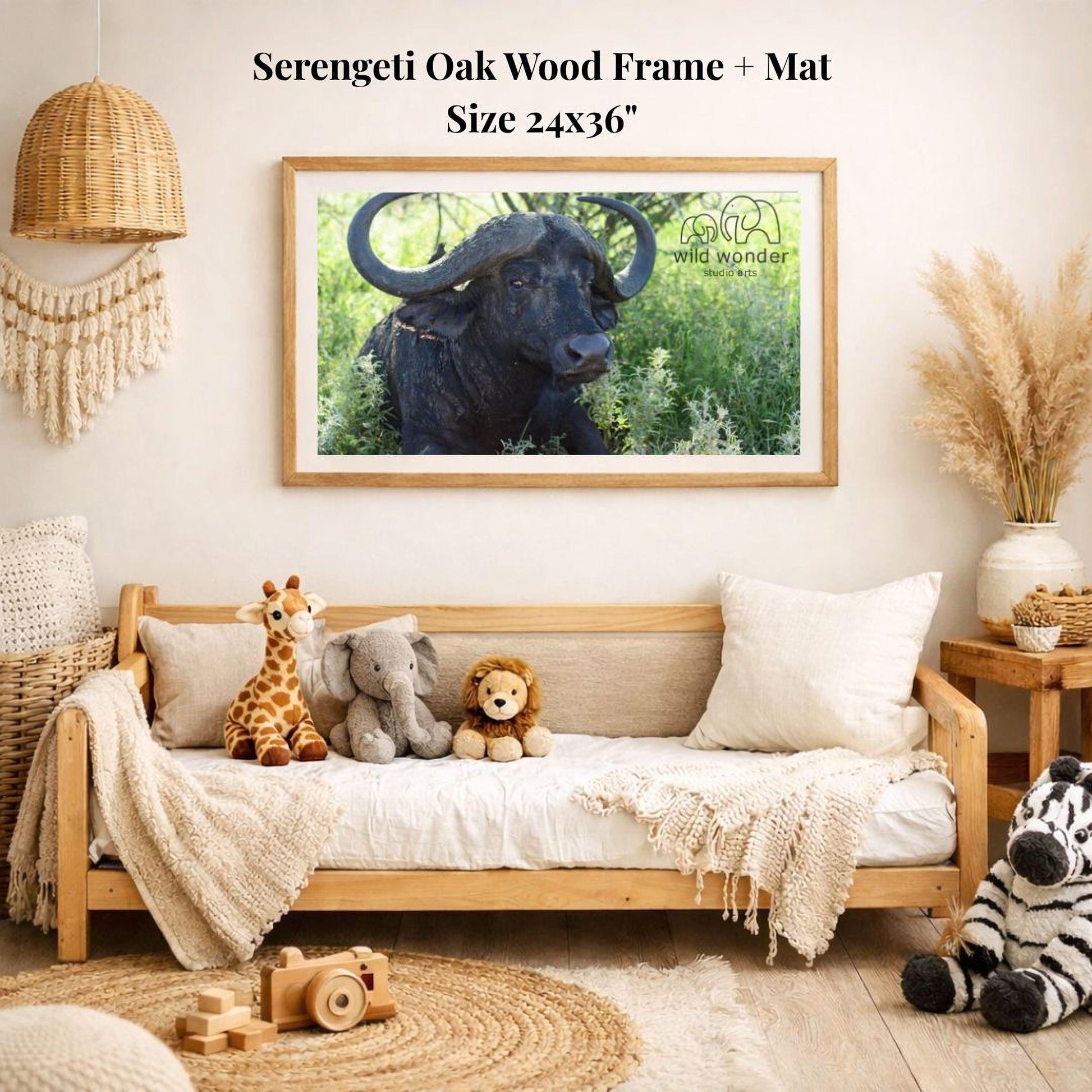 a serene indoor setting with a wooden frame and mat hanging on the wall, displaying a photograph of a horned animal, likely a buffalo or ox, in a natural environment. The frame is surrounded by various stuffed animals, including a giraffe, an elephant, and a lion, creating a cozy and playful atmosphere.