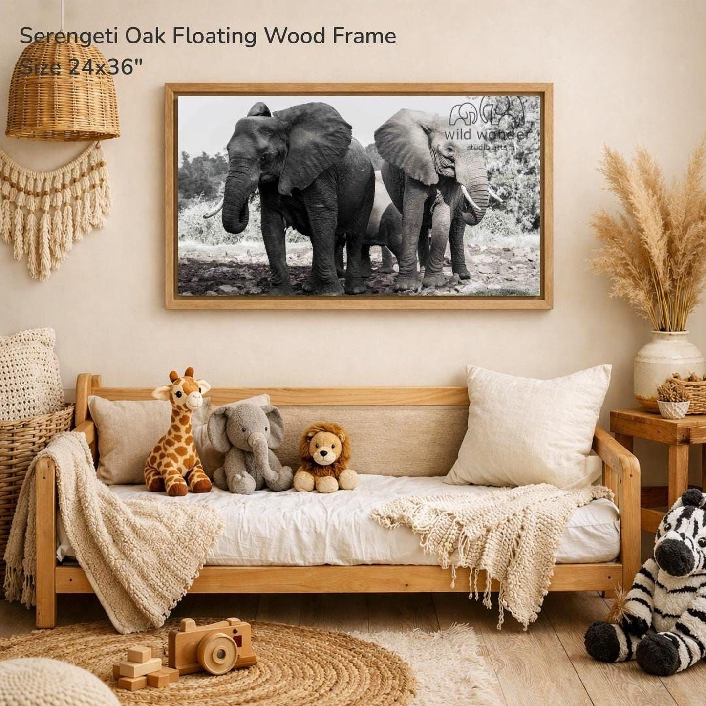 a serene indoor setting with a wooden frame hanging on the wall, displaying a black and white photograph of three elephants. The frame is placed above a couch, which is adorned with stuffed animals, including a giraffe, an elephant, and a lion. The overall scene conveys a sense of warmth and comfort, with the elephants and their surroundings creating a peaceful and inviting atmosphere.