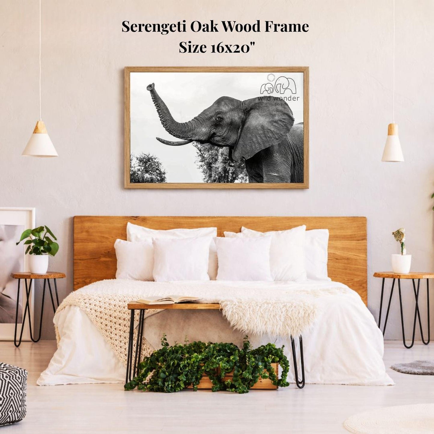 a serene bedroom setting with a large, framed photograph of an elephant on the wall above a bed with white bedding. The room has a wooden headboard and a wooden nightstand on each side of the bed, with a potted plant and a small plant on the nightstands. The overall decor has a natural, calming aesthetic.