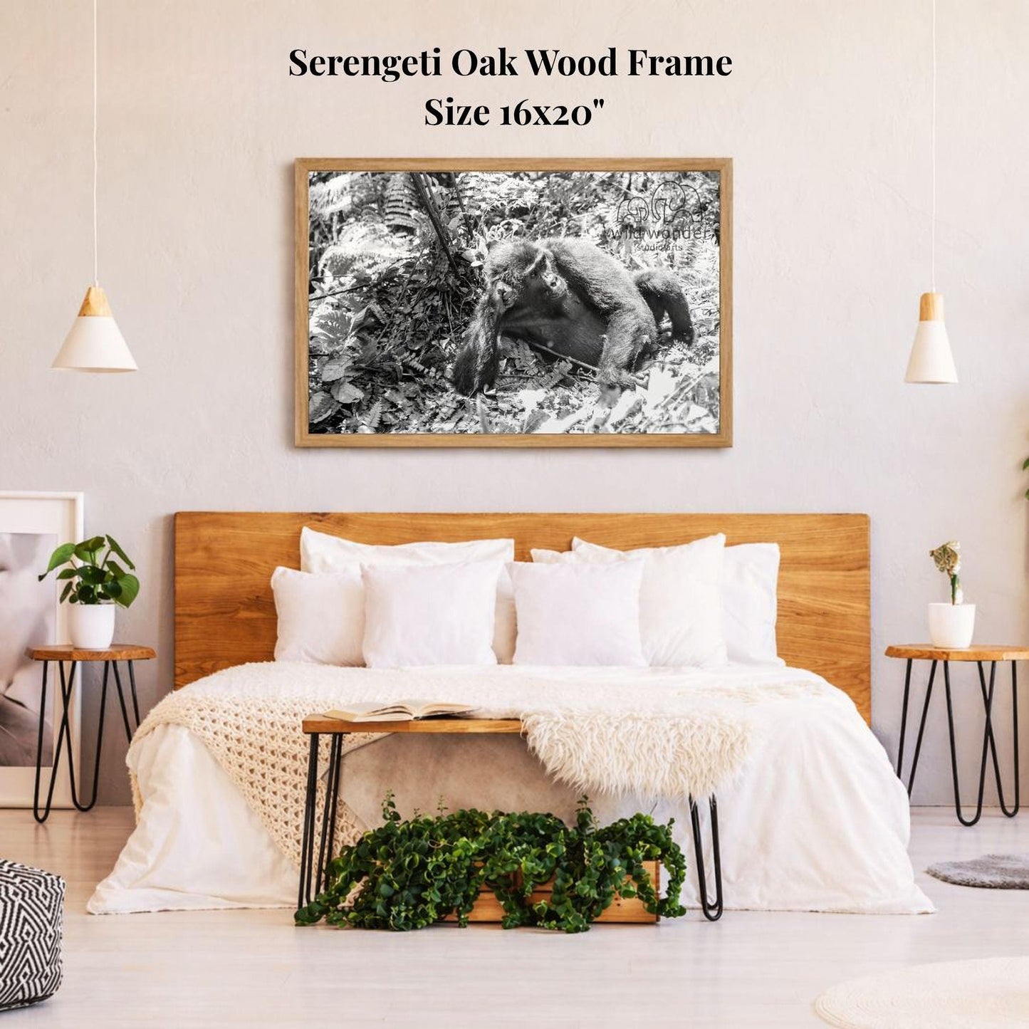 a serene bedroom setting with a large, wooden bed and a framed black and white photograph of a monkey on the wall above it. The room has a minimalist and modern design, with a wooden headboard, white bedding, and a potted plant on a side table.