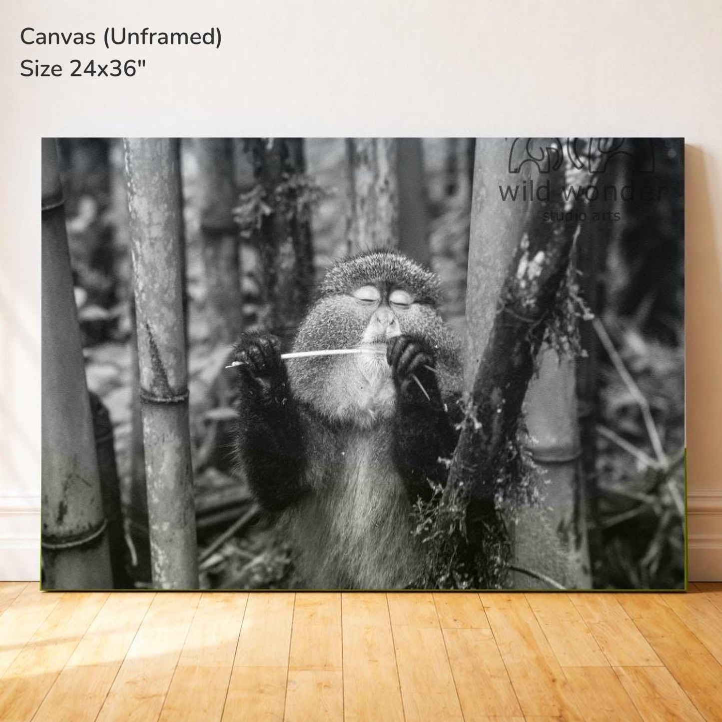 A monkey is sitting in a forest, holding a stick and appearing to play it.