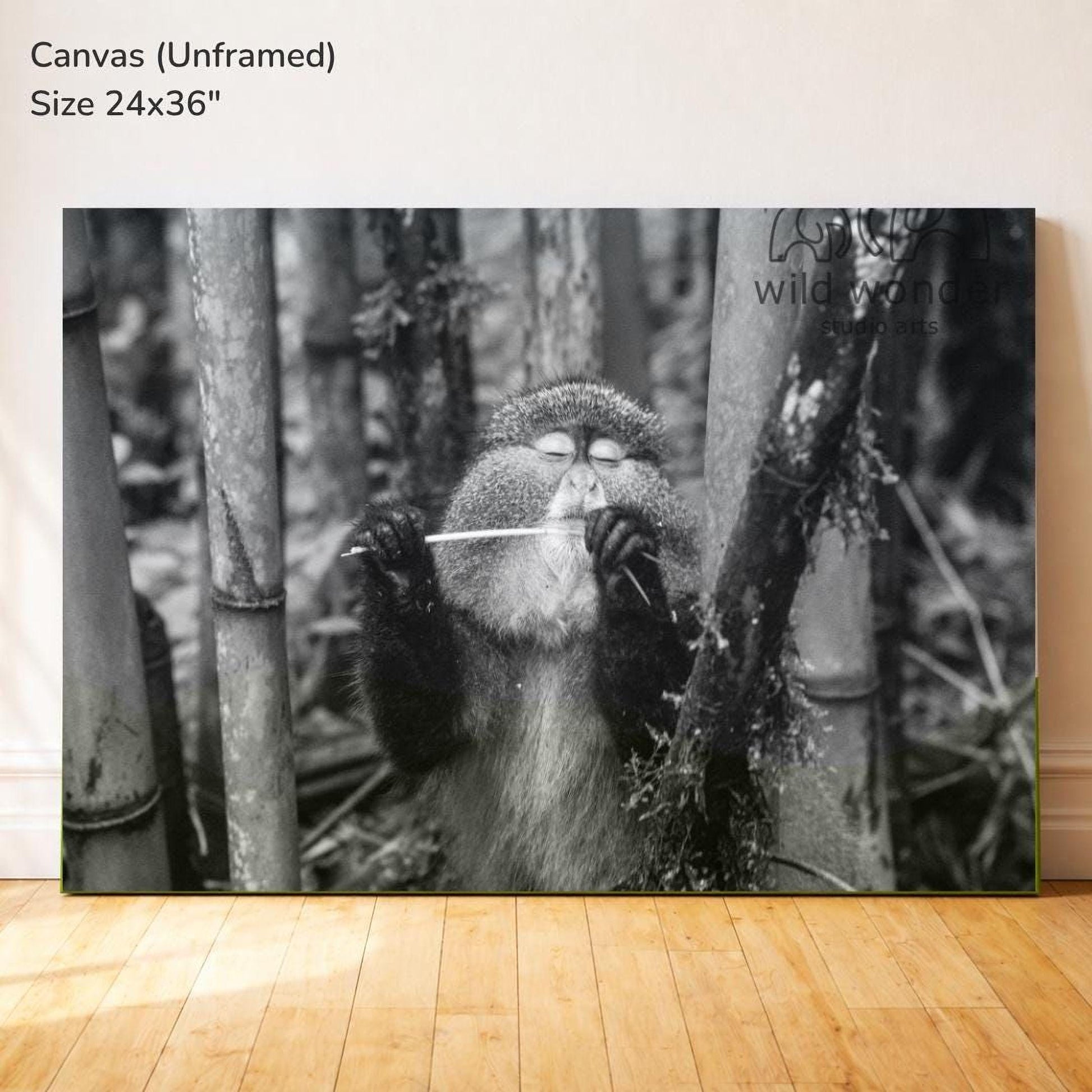 A monkey is sitting in a forest, holding a stick and appearing to play it.