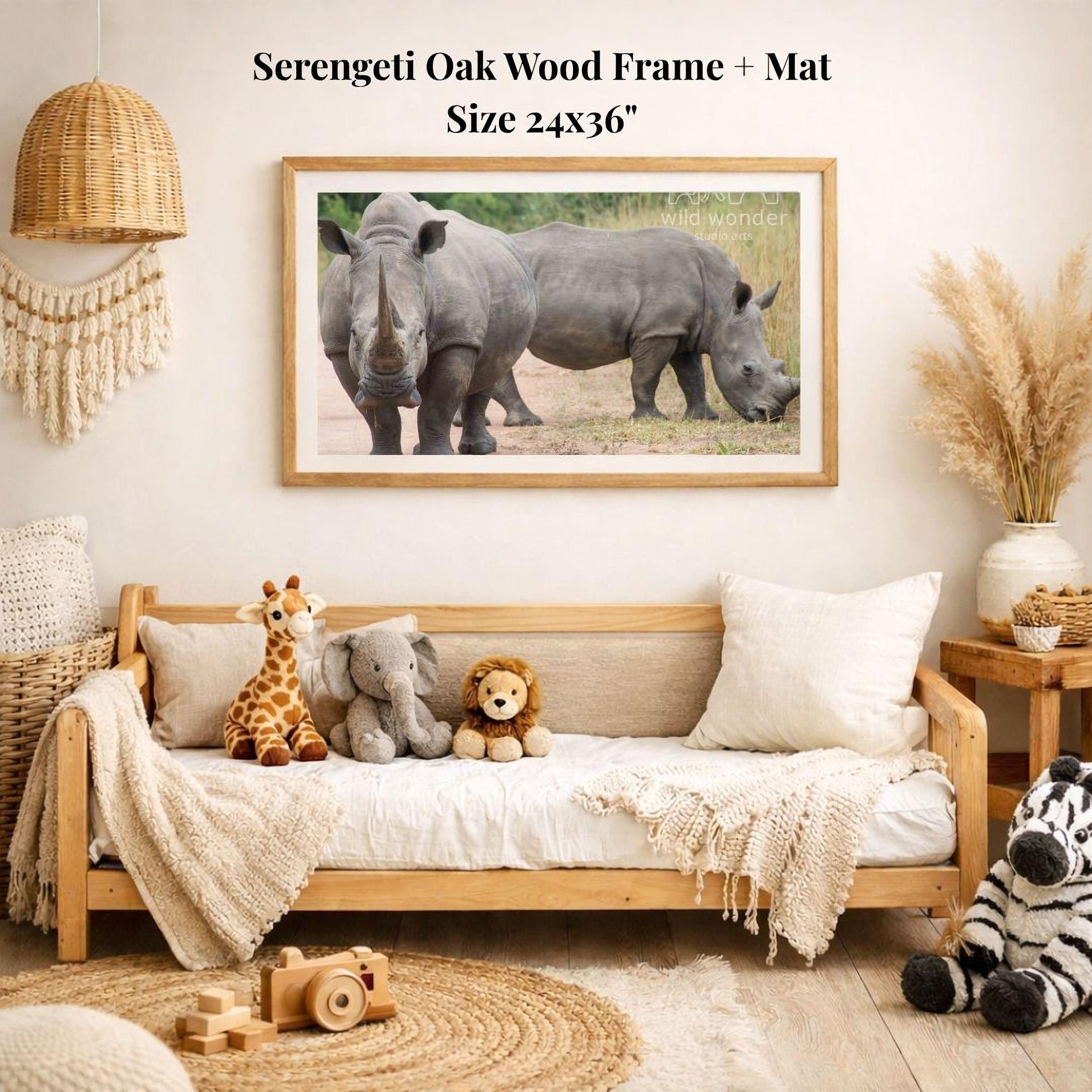 a serene indoor setting with a wooden frame and mat hanging on the wall, displaying a photograph of two rhinos. The frame is surrounded by various stuffed animals, including a giraffe, an elephant, and a lion, creating a cozy and playful atmosphere.