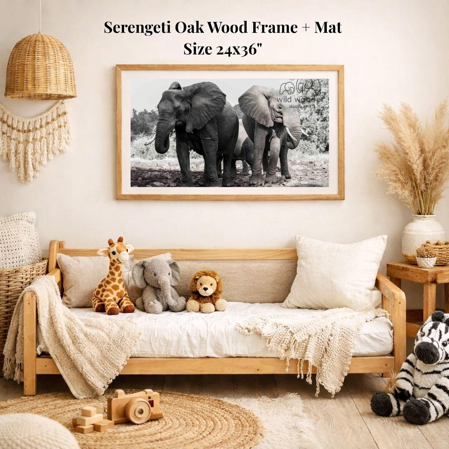 a cozy living room with a large framed black and white photograph of two elephants on the wall, surrounded by various stuffed animals and a woven basket.