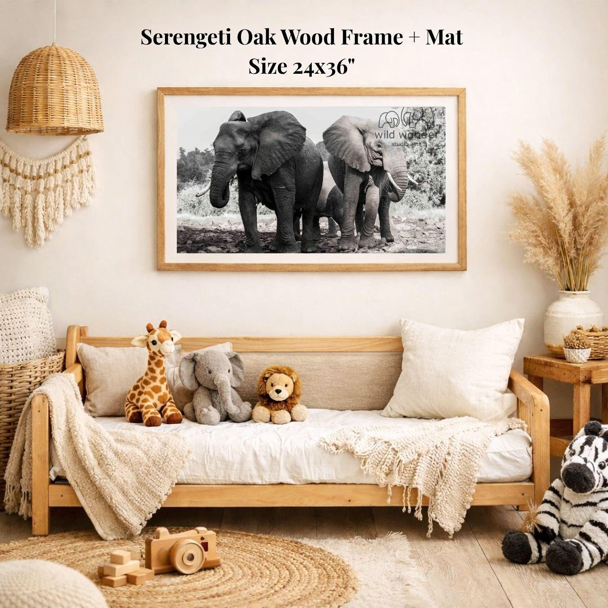 a cozy living room with a large framed black and white photograph of two elephants on the wall, surrounded by various stuffed animals and a woven basket.