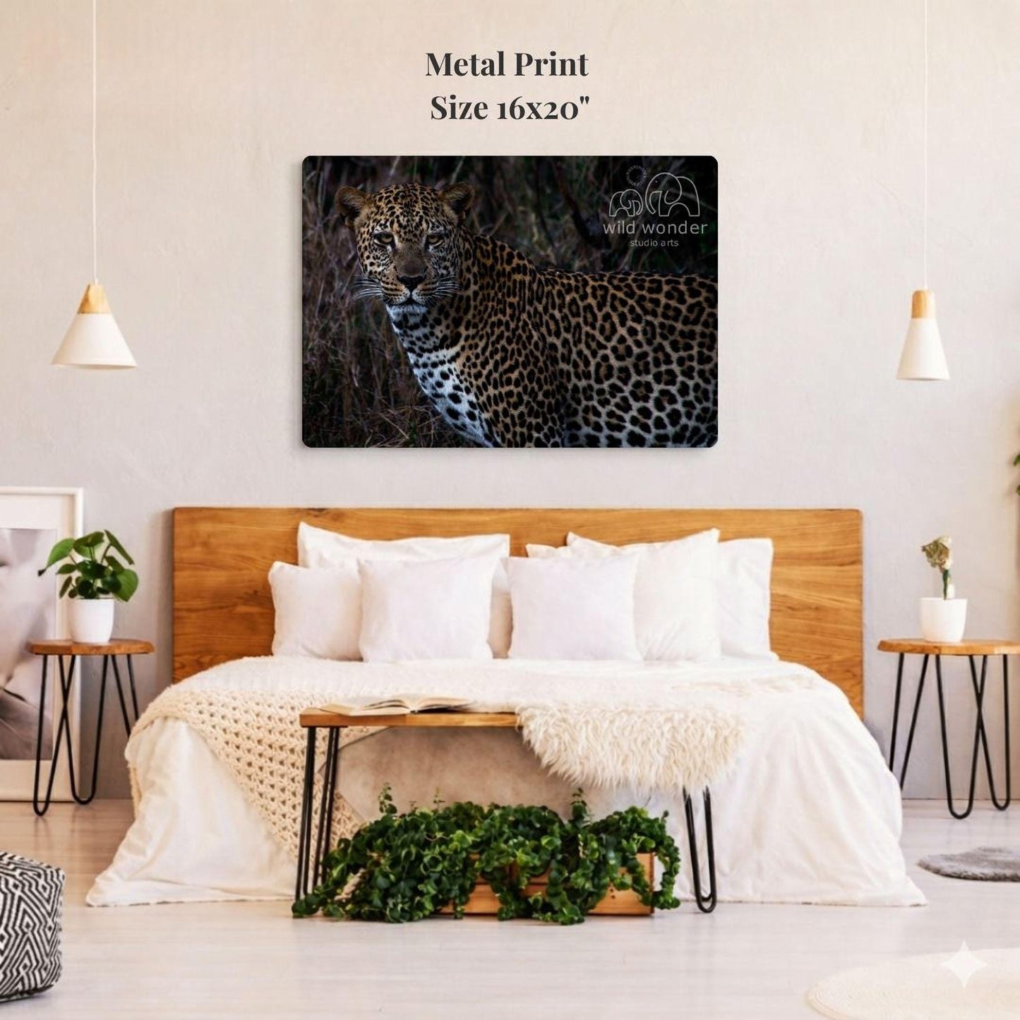 a large metal print of a leopard on a wall above a bed with white bedding and pillows.