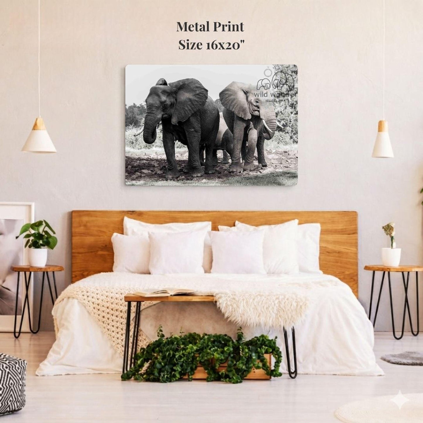 a large black and white photograph of two elephants standing next to each other, with a wooden headboard and a cozy bed in the foreground.