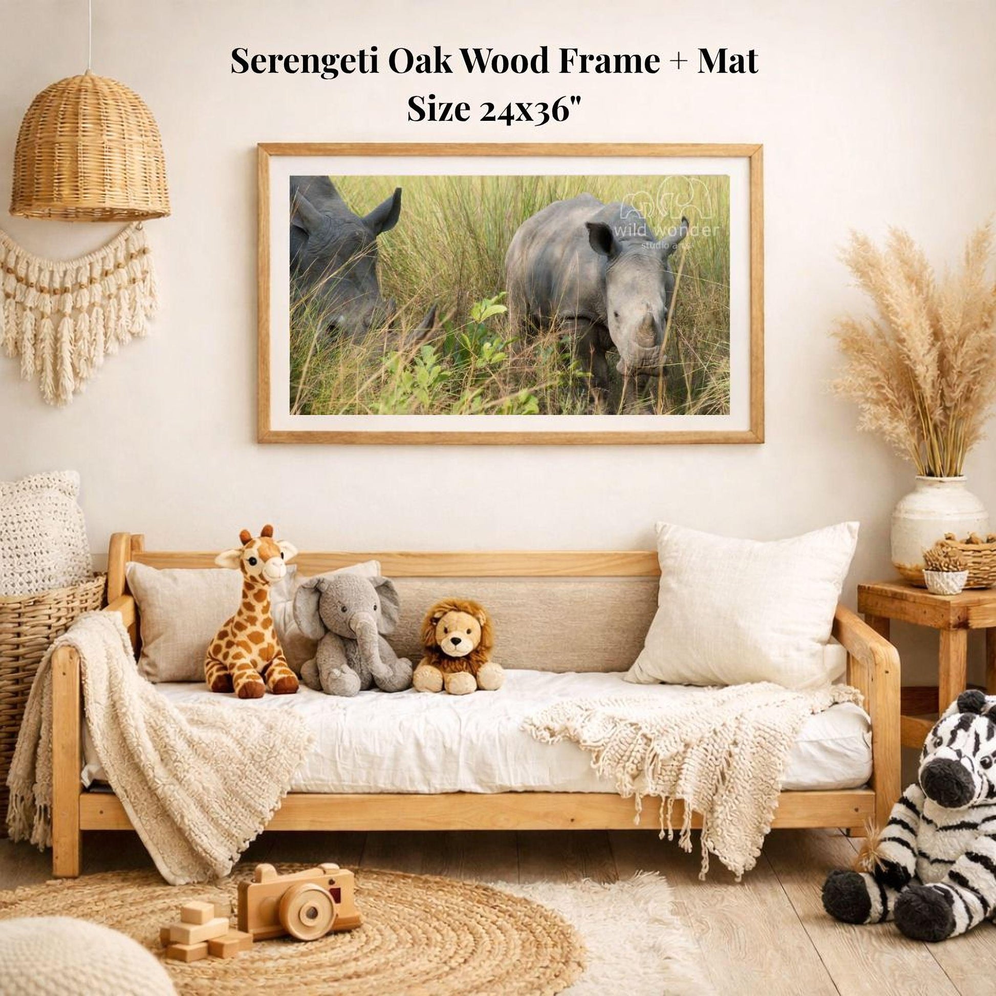 a serene indoor setting with a wooden frame and mat hanging on a wall, displaying a photograph of two rhinos in a grassy field. The frame is surrounded by various stuffed animals, including a giraffe, an elephant, and a lion, creating a cozy and playful atmosphere.