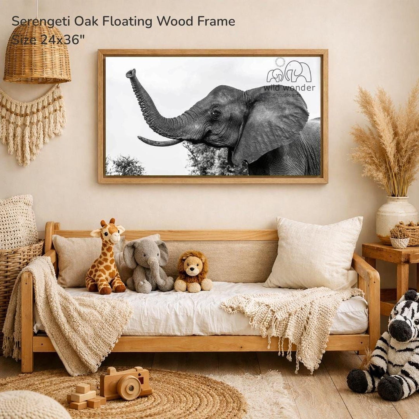 a serene indoor setting with a wooden frame hanging on a wall, displaying a black and white photograph of an elephant. The frame is surrounded by various stuffed animals, including a giraffe, an elephant, and a lion, creating a cozy and playful atmosphere.