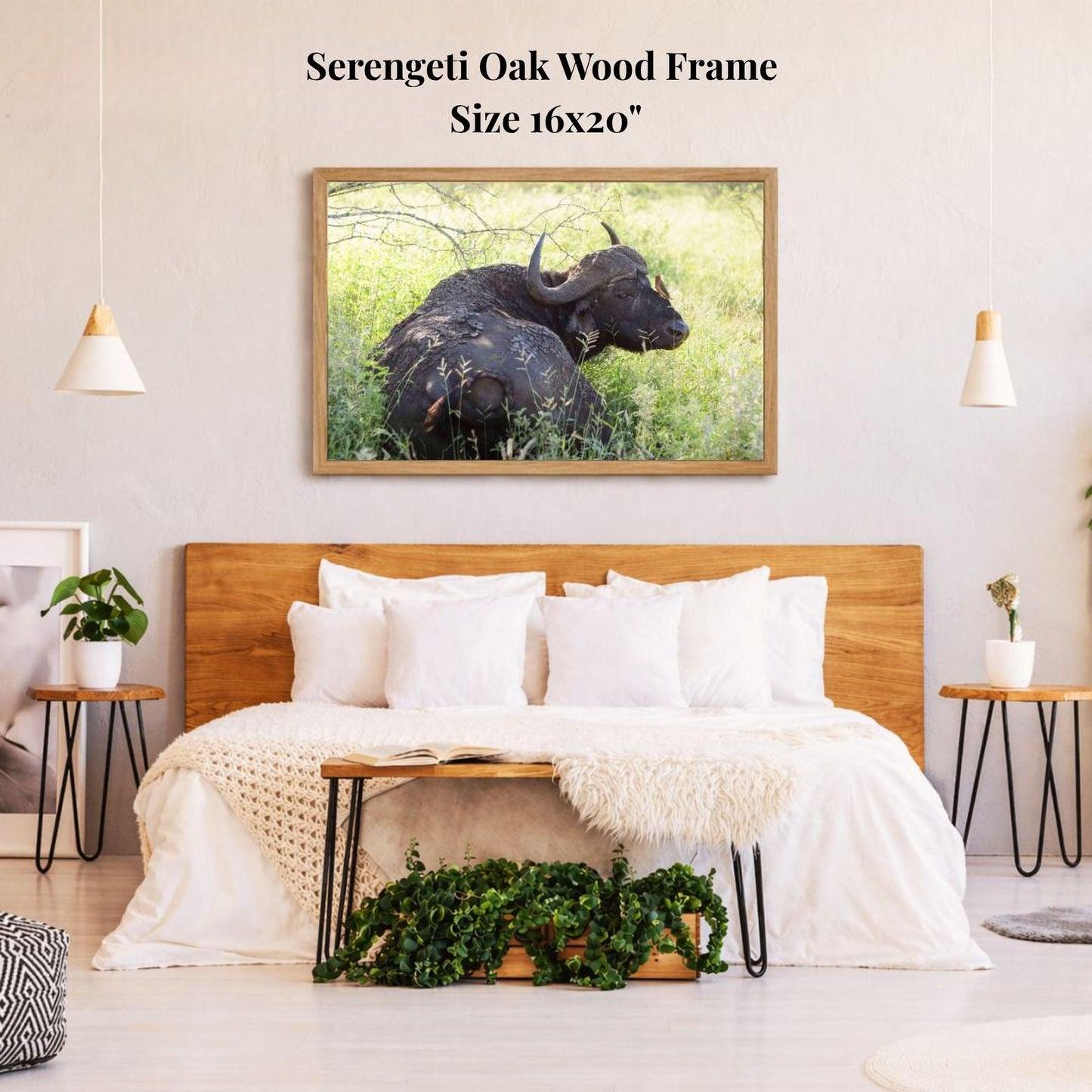 a serene bedroom setting with a large, 16x20" framed photograph of a serene oak wood frame hanging on the wall above a bed with white bedding.