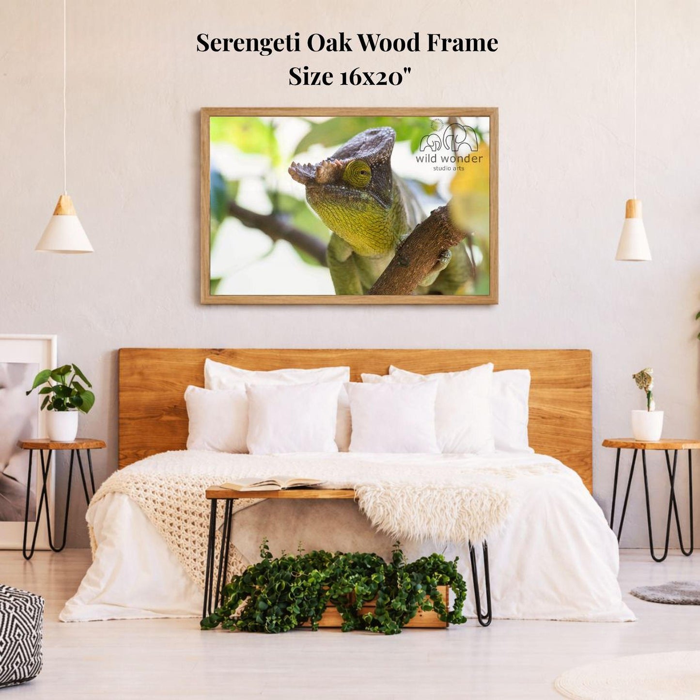 a serene bedroom setting with a large framed photograph of a chameleon on the wall above a bed with white bedding. The room has a wooden headboard and a wooden nightstand on each side of the bed, with a potted plant and a small plant on the nightstands. The overall decor has a natural and calming aesthetic.