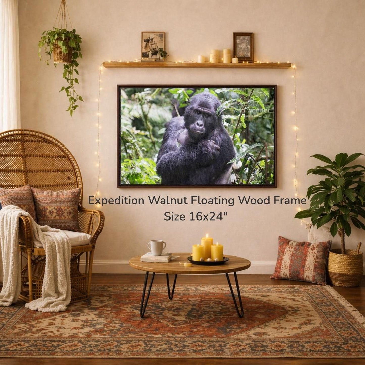 a large, 16x24" walnut floating wood frame hanging on a wall, with a framed photograph of a gorilla on it. The room has a cozy, rustic atmosphere with a wicker chair, a coffee table, and a potted plant. The overall scene appears to be a living room or a den, with a focus on the wall art and the natural elements.