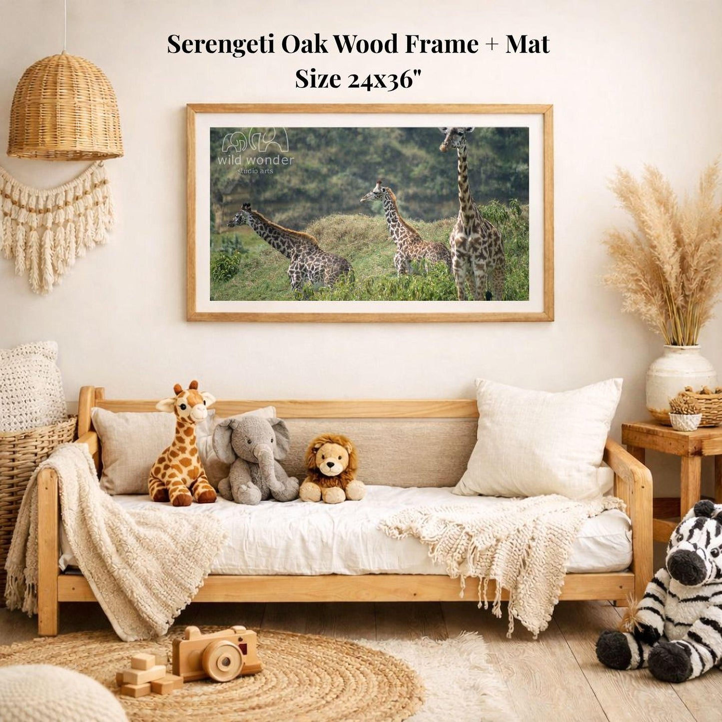 a serene indoor setting with a wooden frame and mat hanging on a wall, displaying a photograph of four giraffes in a grassy field. The frame is surrounded by various stuffed animals, including a giraffe, elephant, lion, and zebra, creating a cozy and playful atmosphere.