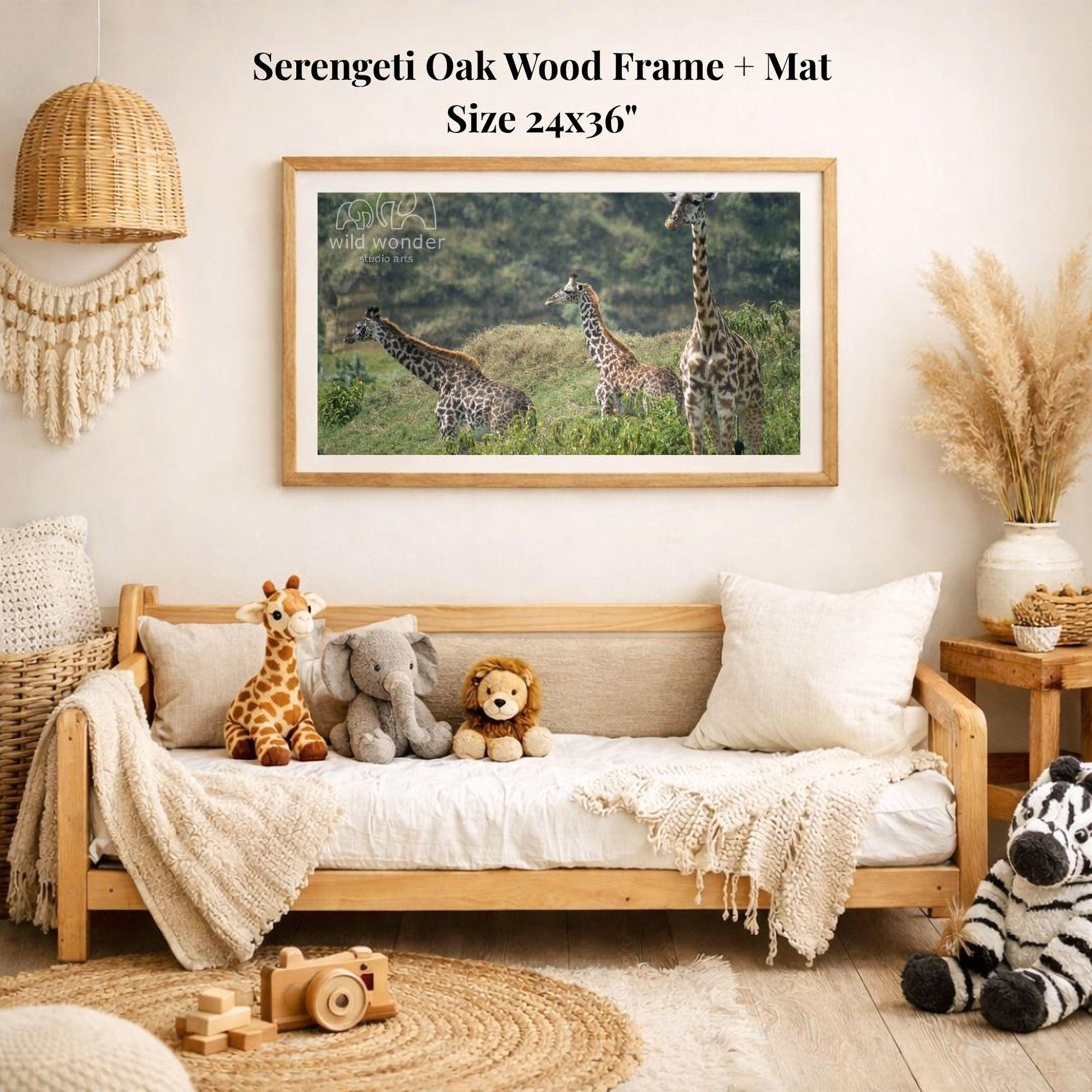 a serene indoor setting with a wooden frame and mat hanging on a wall, displaying a photograph of four giraffes in a grassy field. The frame is surrounded by various stuffed animals, including a giraffe, elephant, lion, and zebra, creating a cozy and playful atmosphere.