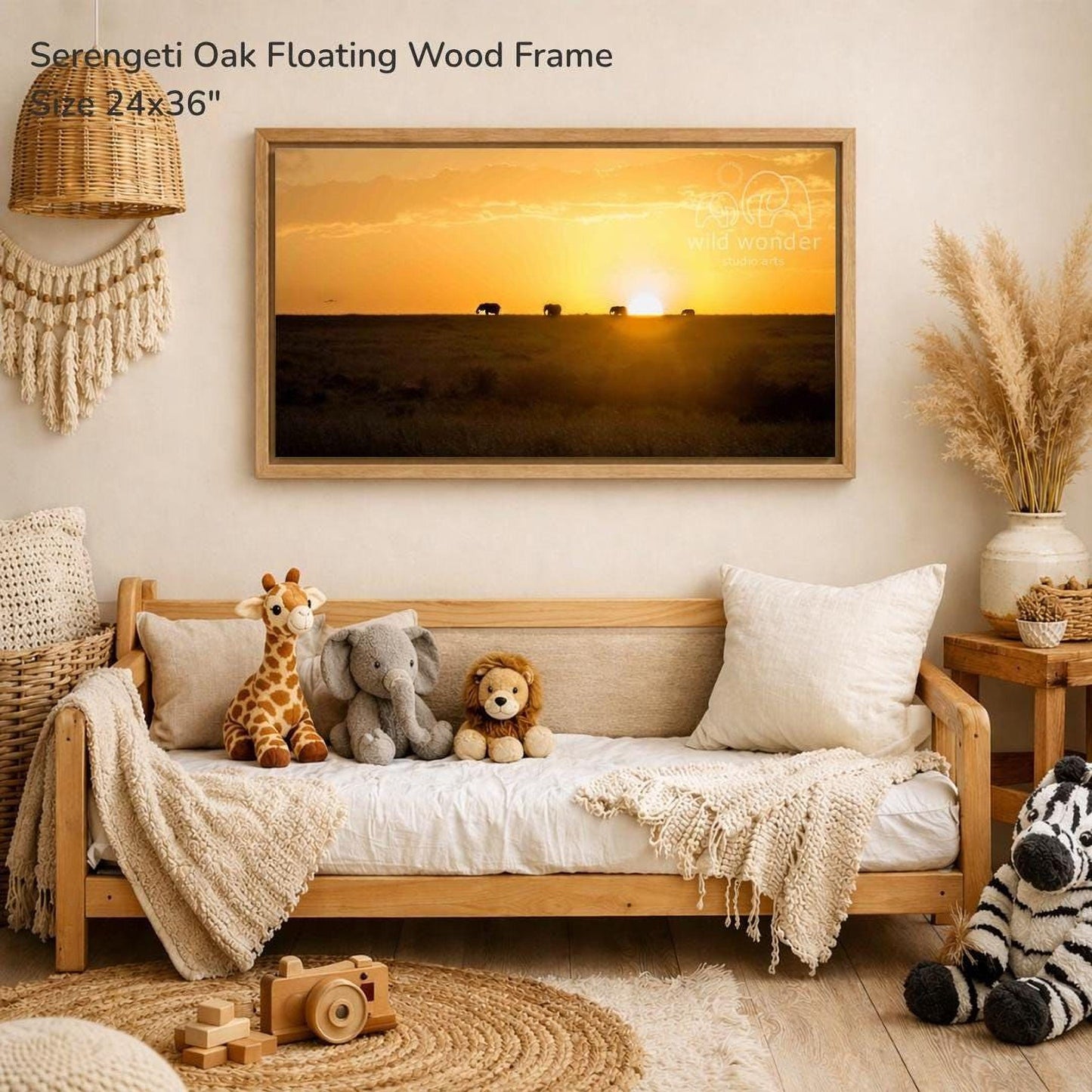 a serene indoor setting with a wooden frame hanging on a wall, displaying a serene sunset scene with animals in the distance. The frame is surrounded by various decorative elements, including a woven basket, a potted plant, and a stuffed animal. The overall atmosphere of the room is warm and inviting, with a touch of rustic charm.