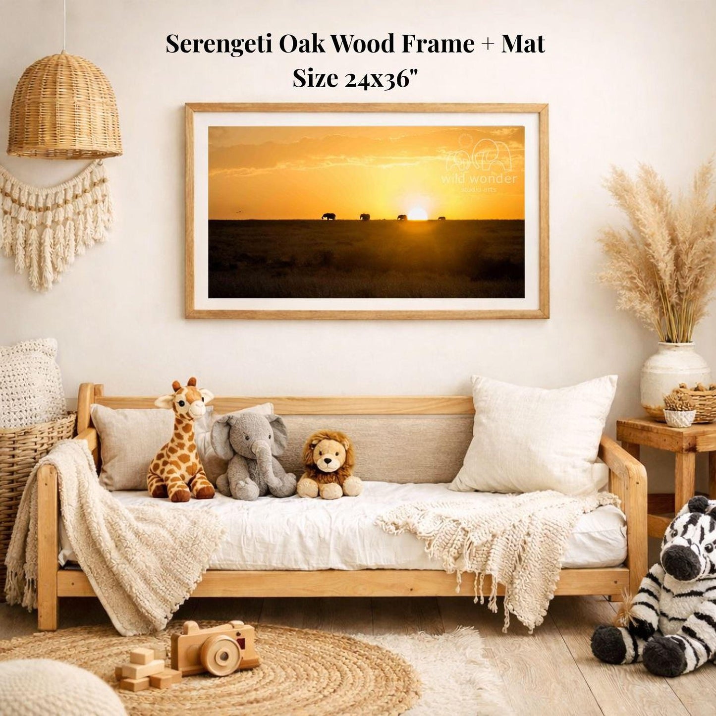 a serene indoor setting with a wooden frame and mat hanging on a wall, displaying a photograph of a sunset over a field. The frame is surrounded by various stuffed animals, including a giraffe, elephant, lion, and zebra, creating a cozy and playful atmosphere.