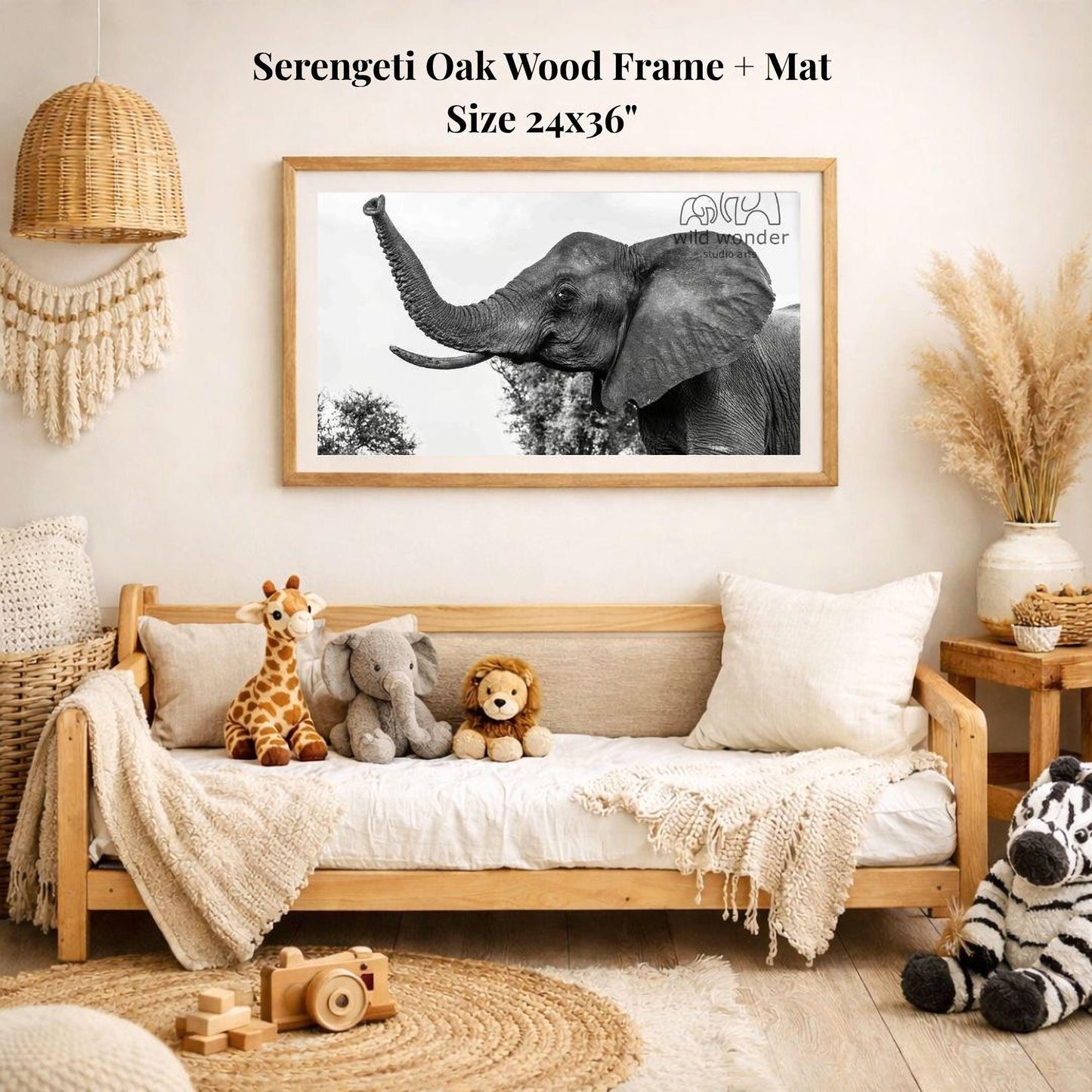 a serene indoor setting with a large framed photograph of an elephant on the wall, surrounded by various stuffed animals and a woven basket.