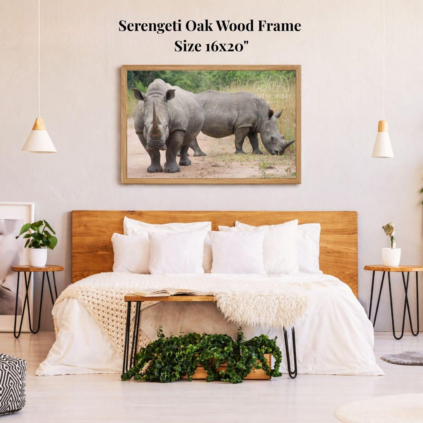 a bedroom with a large wooden headboard and a framed photograph of two rhinos on the wall above it.