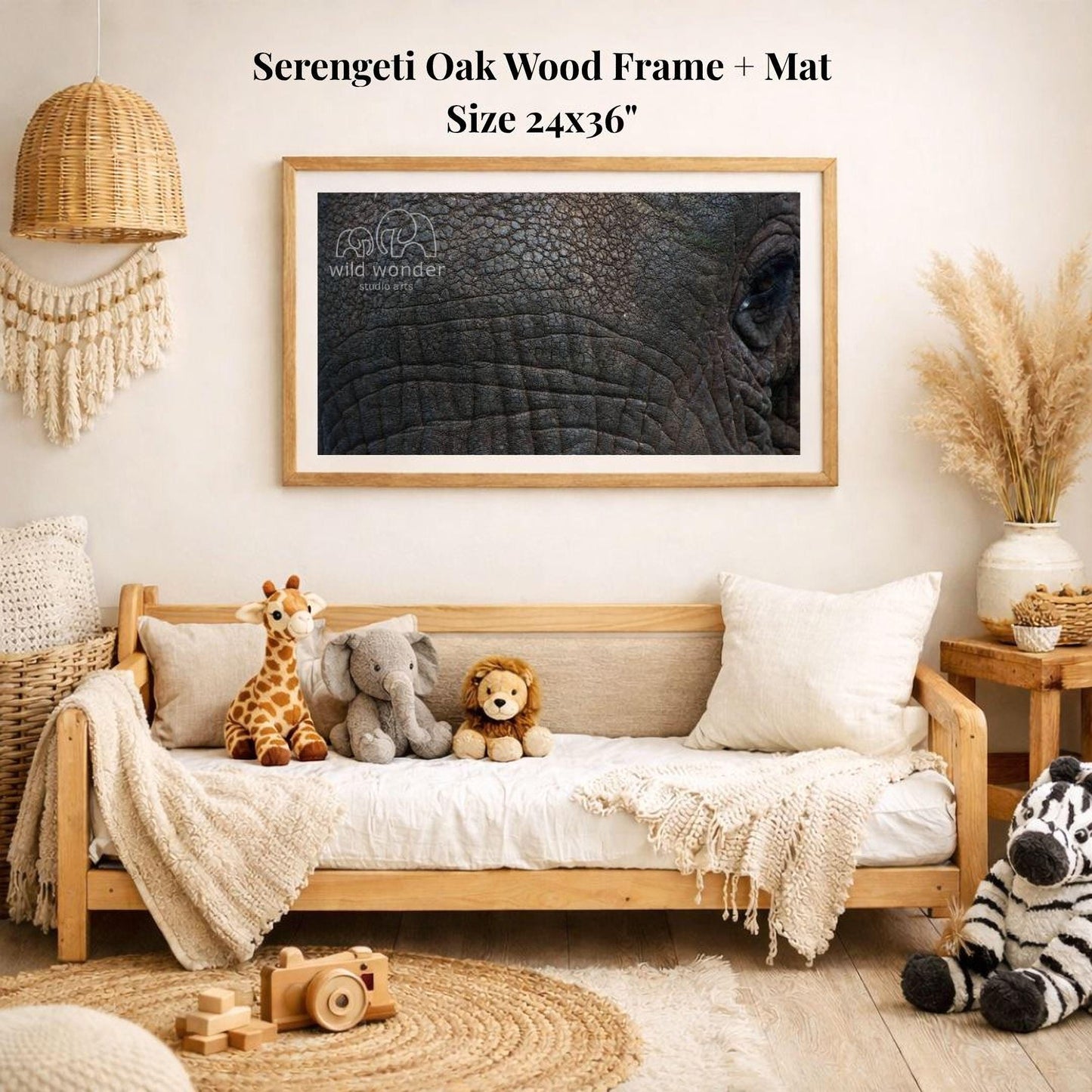 a serene and cozy living room with a large framed photograph of an elephant's eye hanging on the wall. The room is decorated with various stuffed animals, including a giraffe, an elephant, and a lion, arranged on a couch and a bed. The room also has a woven basket, a wooden chair, and a potted plant, creating a warm and inviting atmosphere.