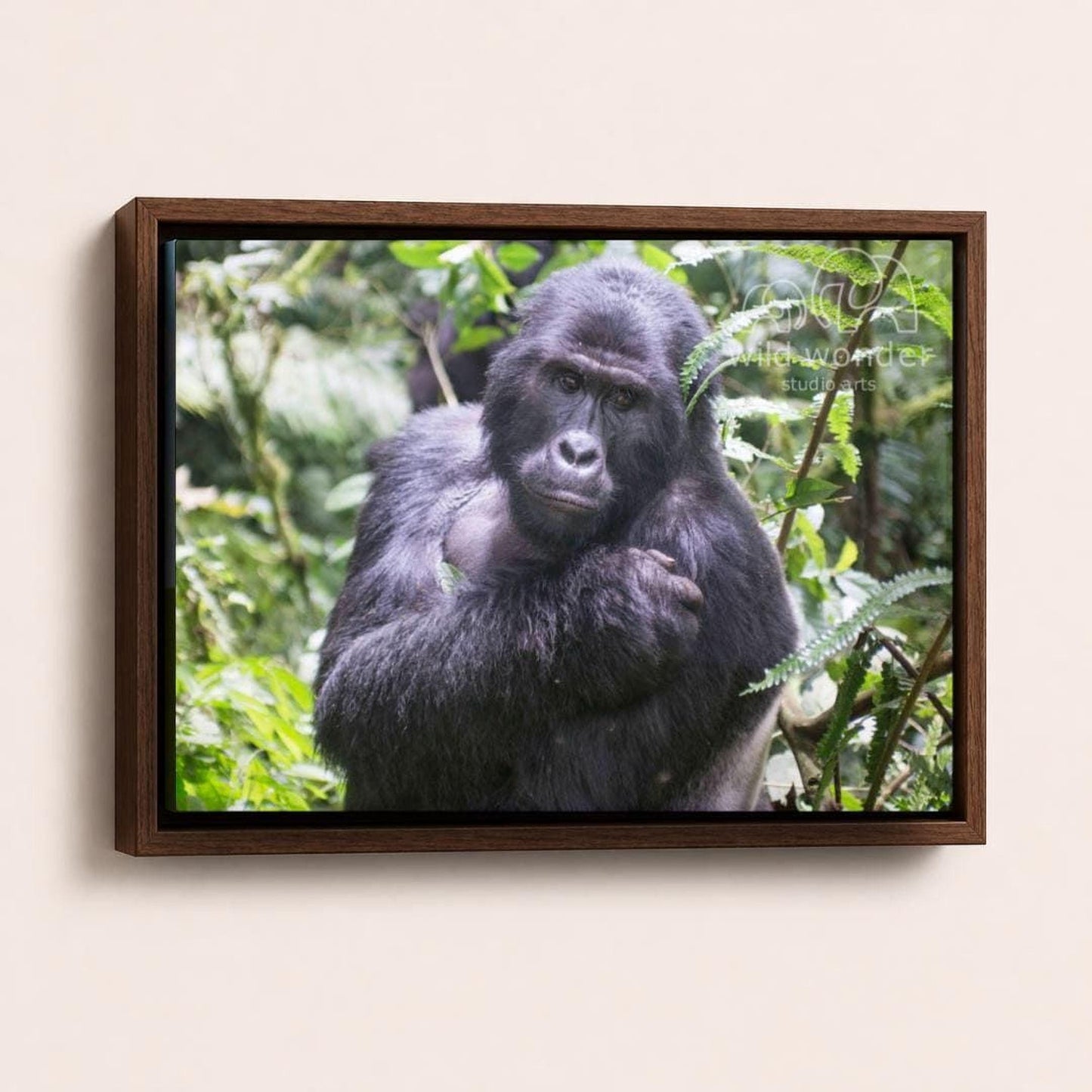 A close-up portrait of a gorilla in a lush, green forest environment.