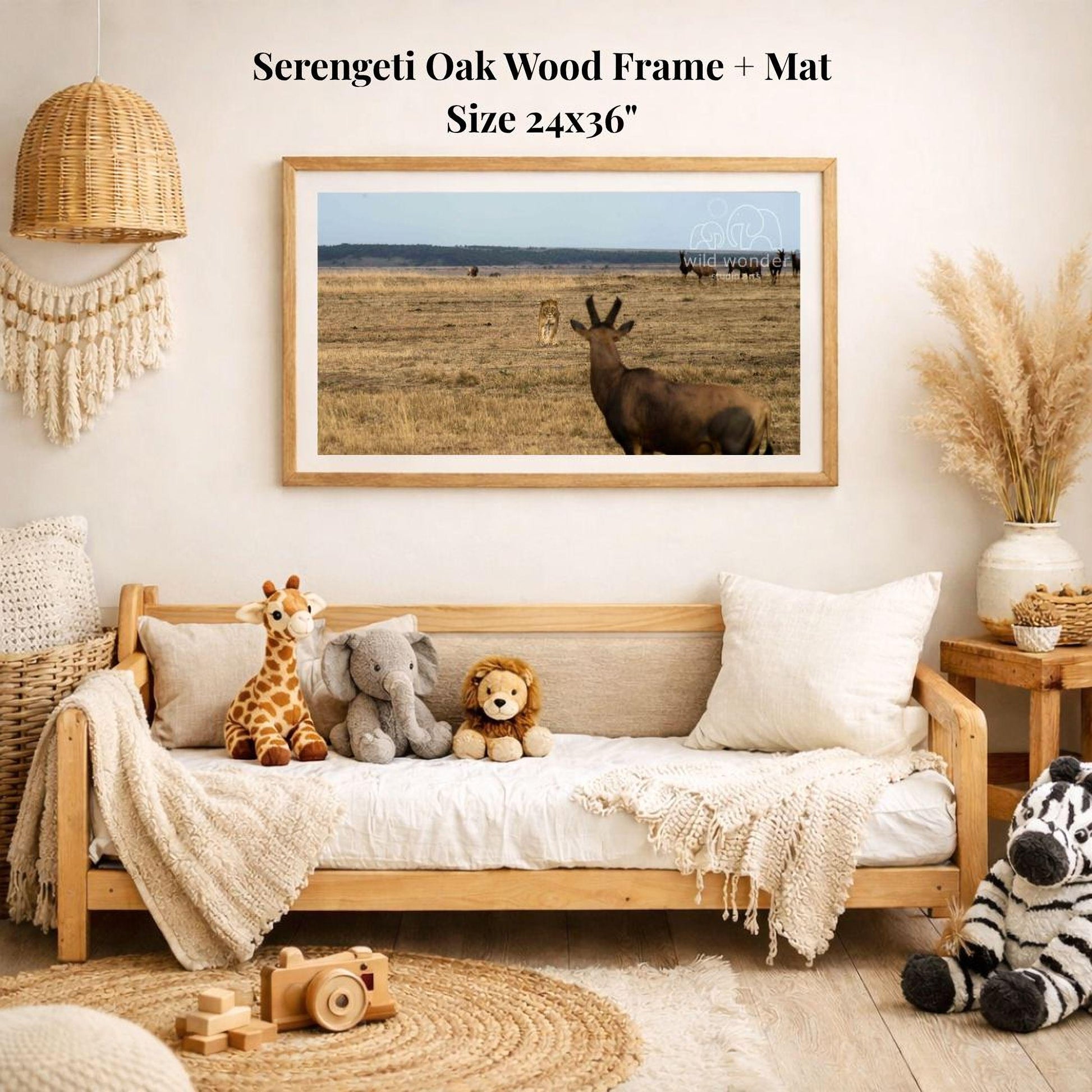 a serene indoor setting with a wooden frame and mat hanging on the wall, displaying a photograph of a serene landscape with a herd of antelope in the background. The room is decorated with various plush toys and a woven basket, creating a cozy and inviting atmosphere.