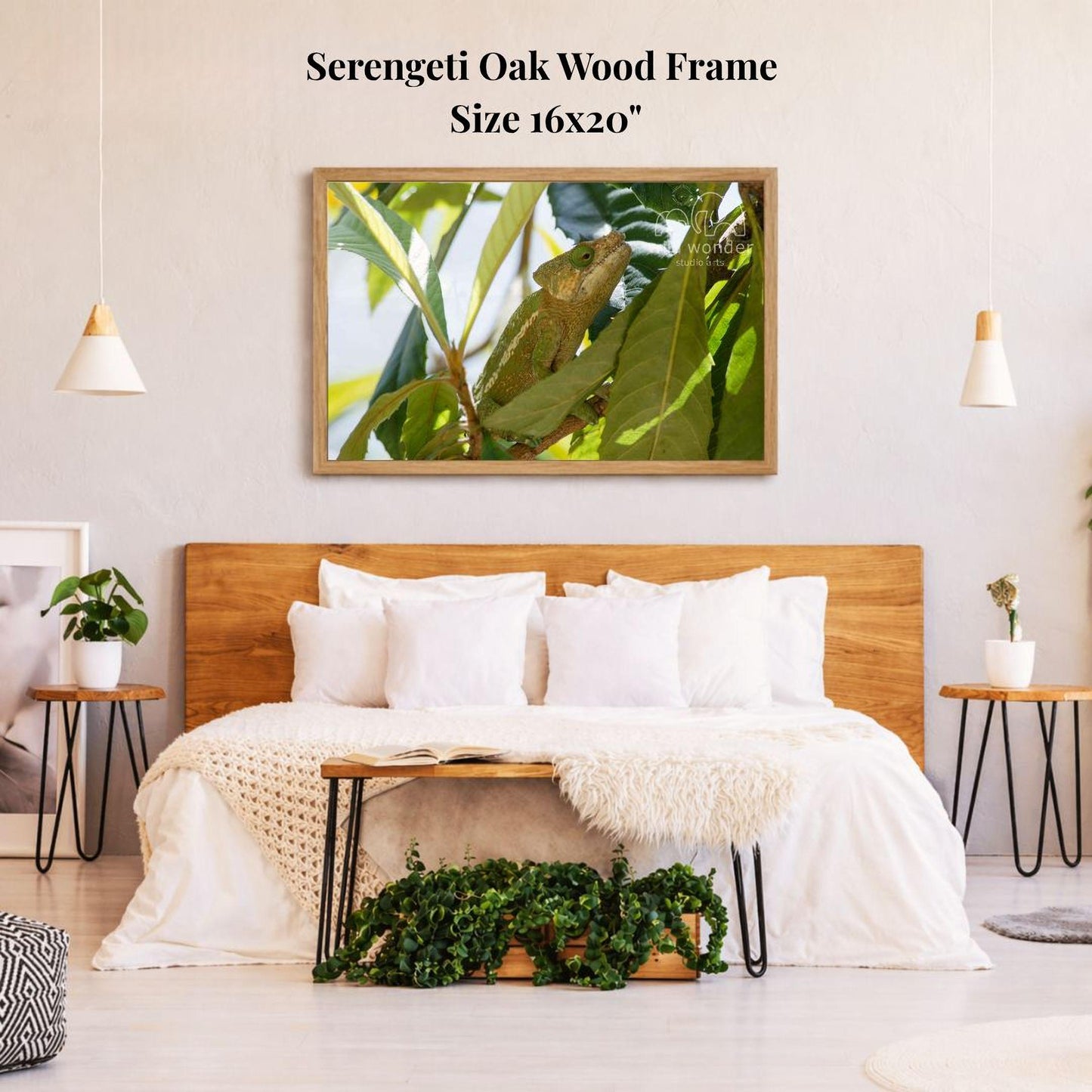 a serene bedroom setting with a large, 16x20" framed picture of a lush green plant hanging on the wall above a bed with white bedding.