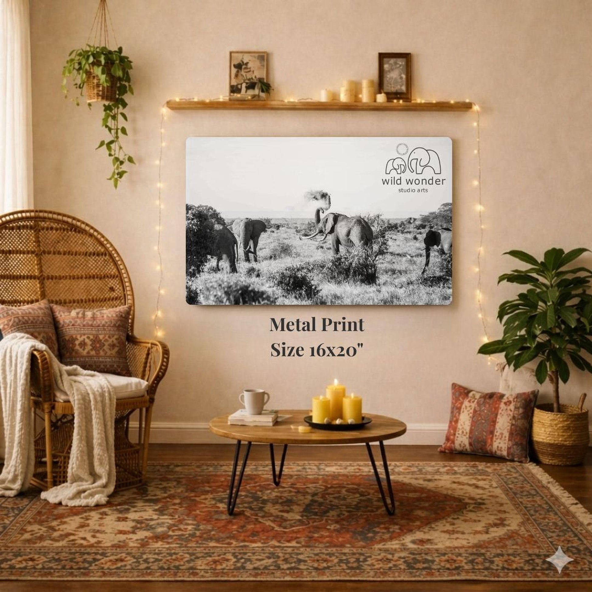 a living room with a large black and white photograph of elephants in a field hanging on the wall. The photograph is framed and has a metal print size of 16x20 inches. The room is decorated with a wicker chair, a coffee table, and various plants, creating a cozy and inviting atmosphere.