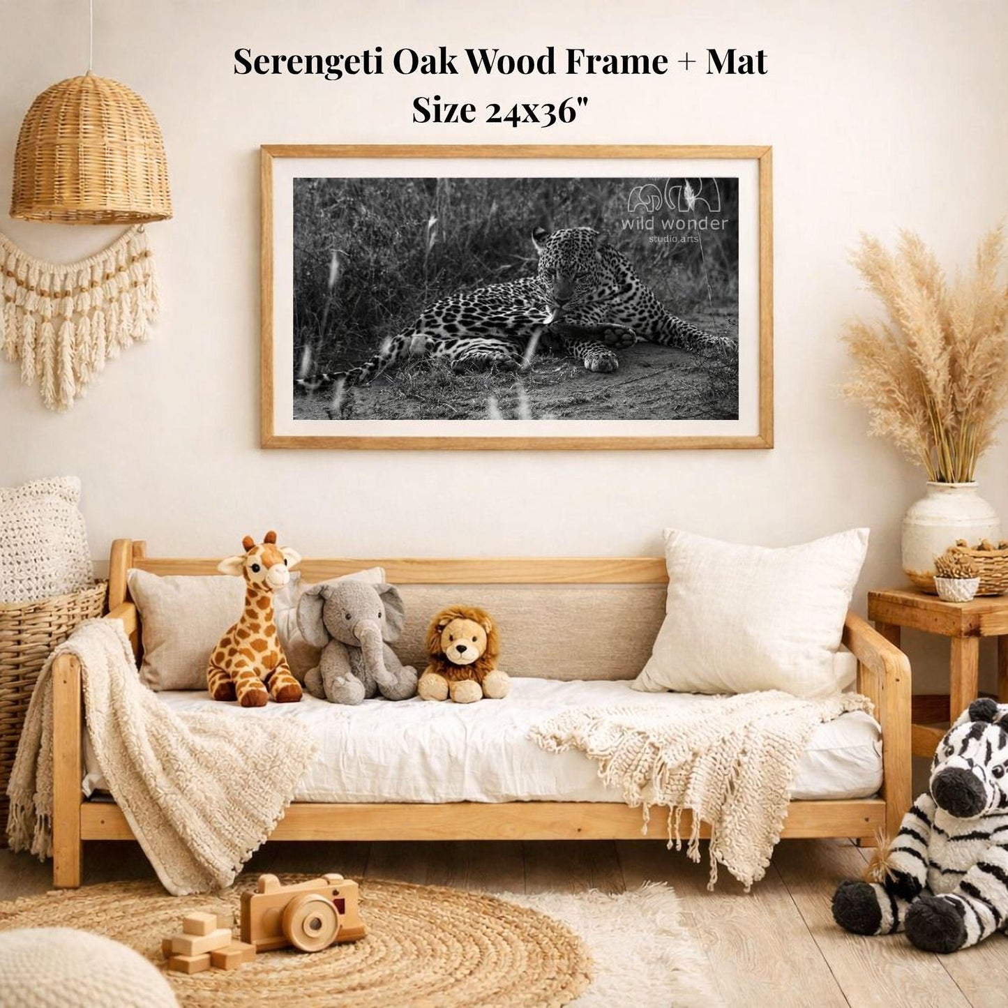a serene indoor setting with a framed black and white photograph of two leopards resting on the ground, surrounded by various stuffed animals and a woven basket.