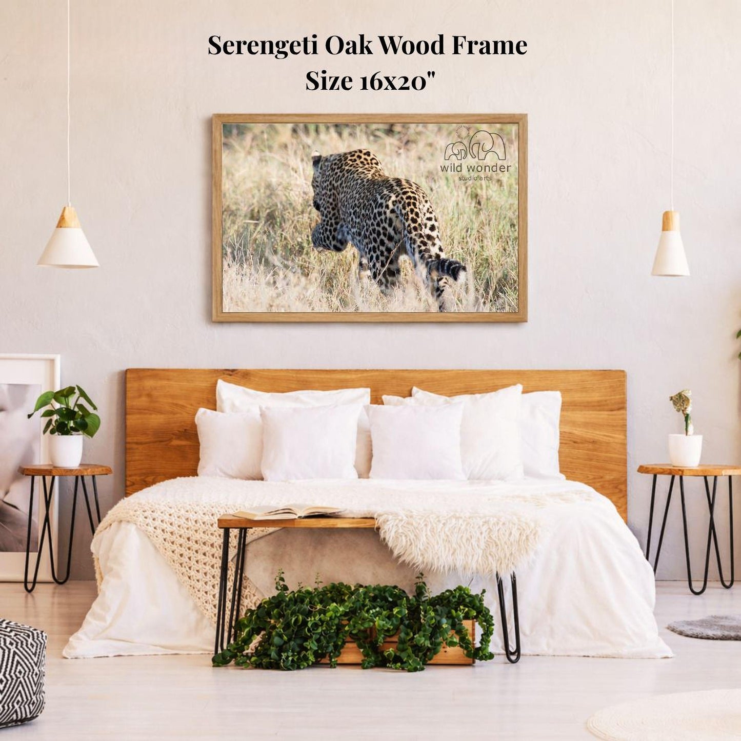 a serene bedroom setting with a large framed photograph of a leopard on the wall above a bed with white bedding.