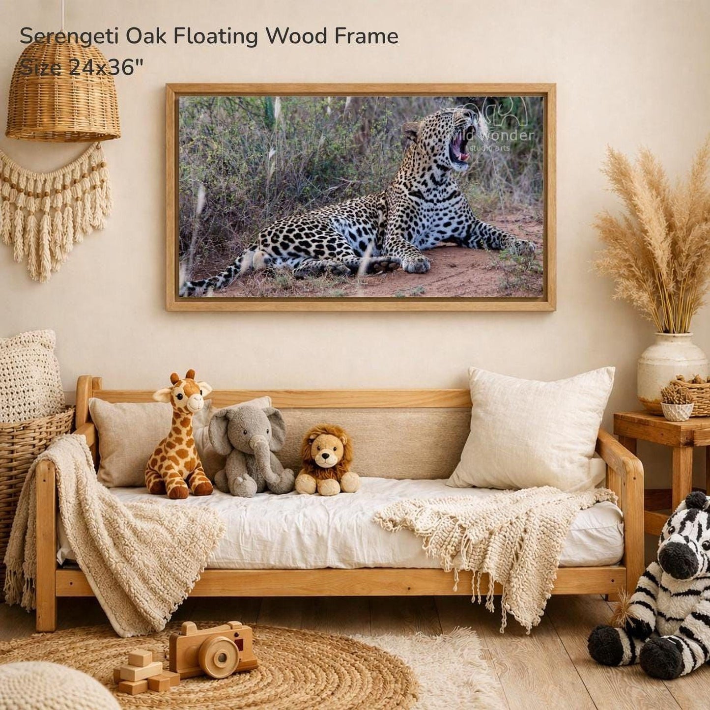 a serene indoor setting with a large framed photograph of a leopard resting on the wall, surrounded by various stuffed animals and a wooden frame.