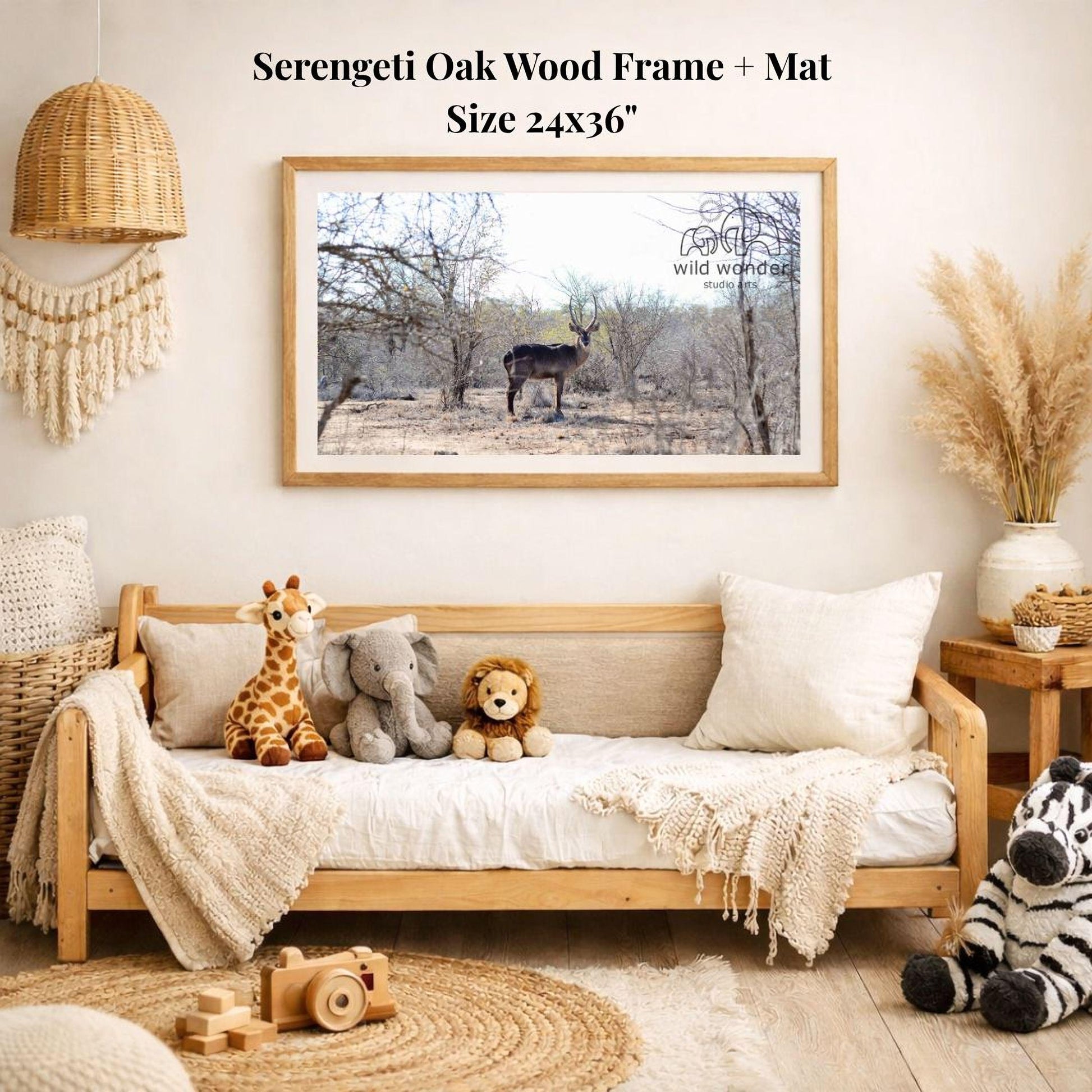 a serene indoor setting with a wooden frame and mat hanging on the wall, displaying a photograph of a serene outdoor scene with a deer and trees. The frame is surrounded by various stuffed animals, including a giraffe, elephant, lion, and zebra, creating a cozy and playful atmosphere.