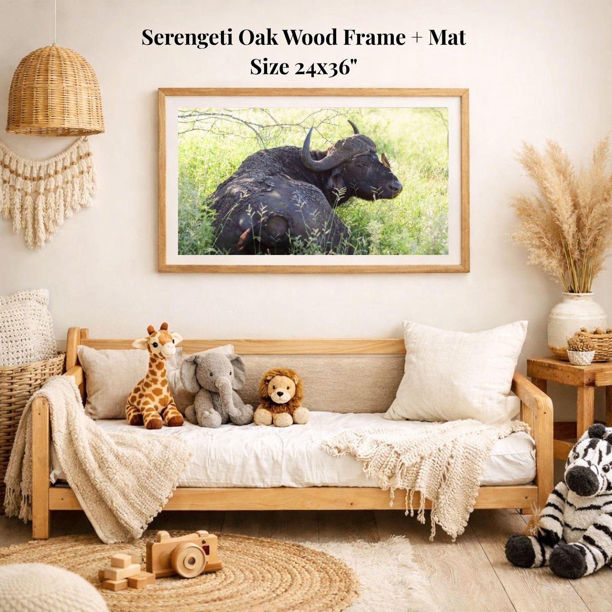 a serene indoor setting with a wooden frame and mat hanging on the wall, displaying a photograph of a buffalo in a grassy field. The room is decorated with various stuffed animals, including a giraffe, elephant, lion, and zebra, arranged on a couch and a rug.
