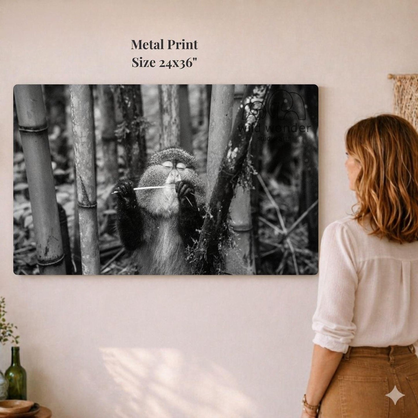 A woman is standing in front of a large metal print depicting a monkey in a forest setting.