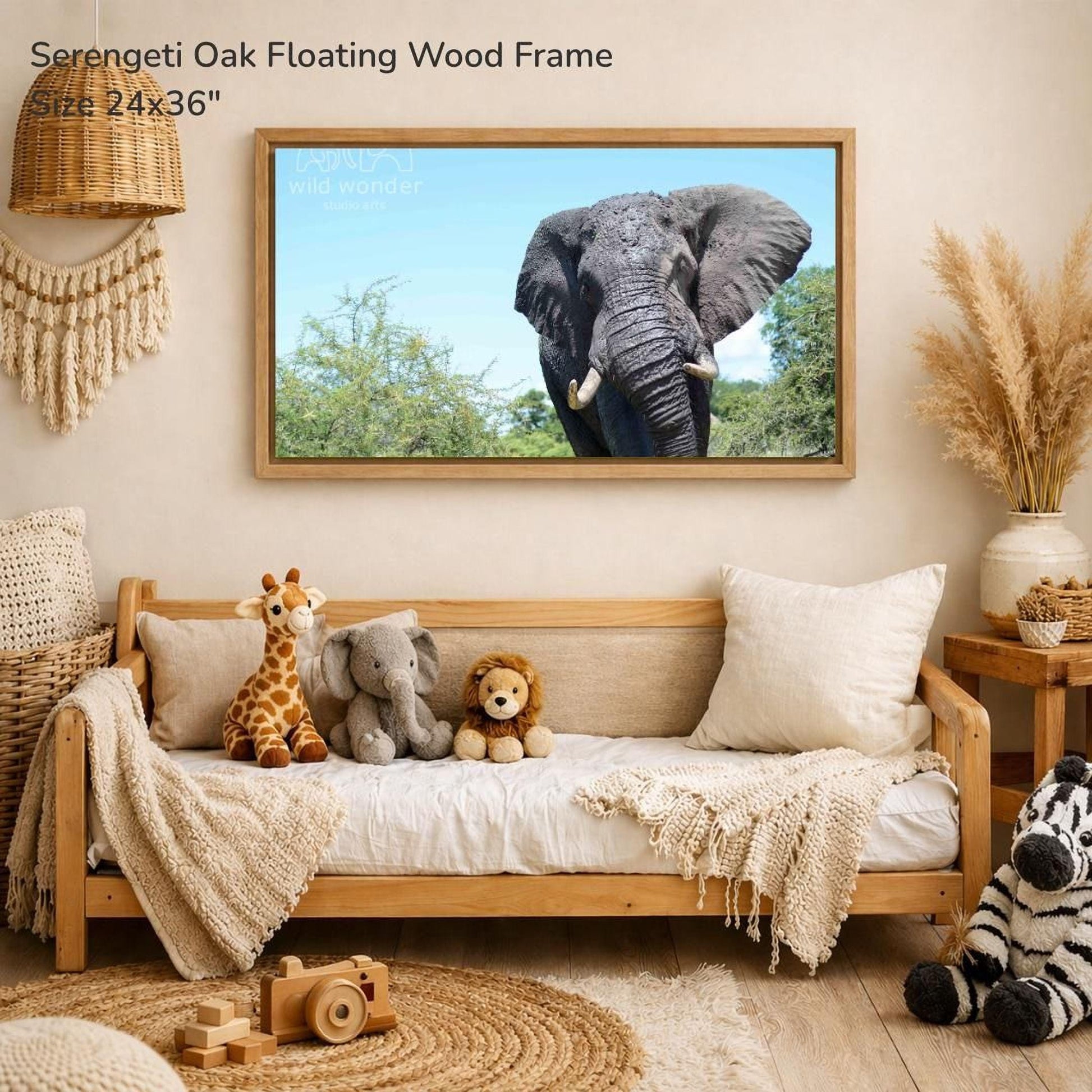 a serene indoor setting with a wooden frame hanging on a wall, displaying a photograph of an elephant. The frame is surrounded by various stuffed animals, including a giraffe, an elephant, and a lion, creating a cozy and playful atmosphere.