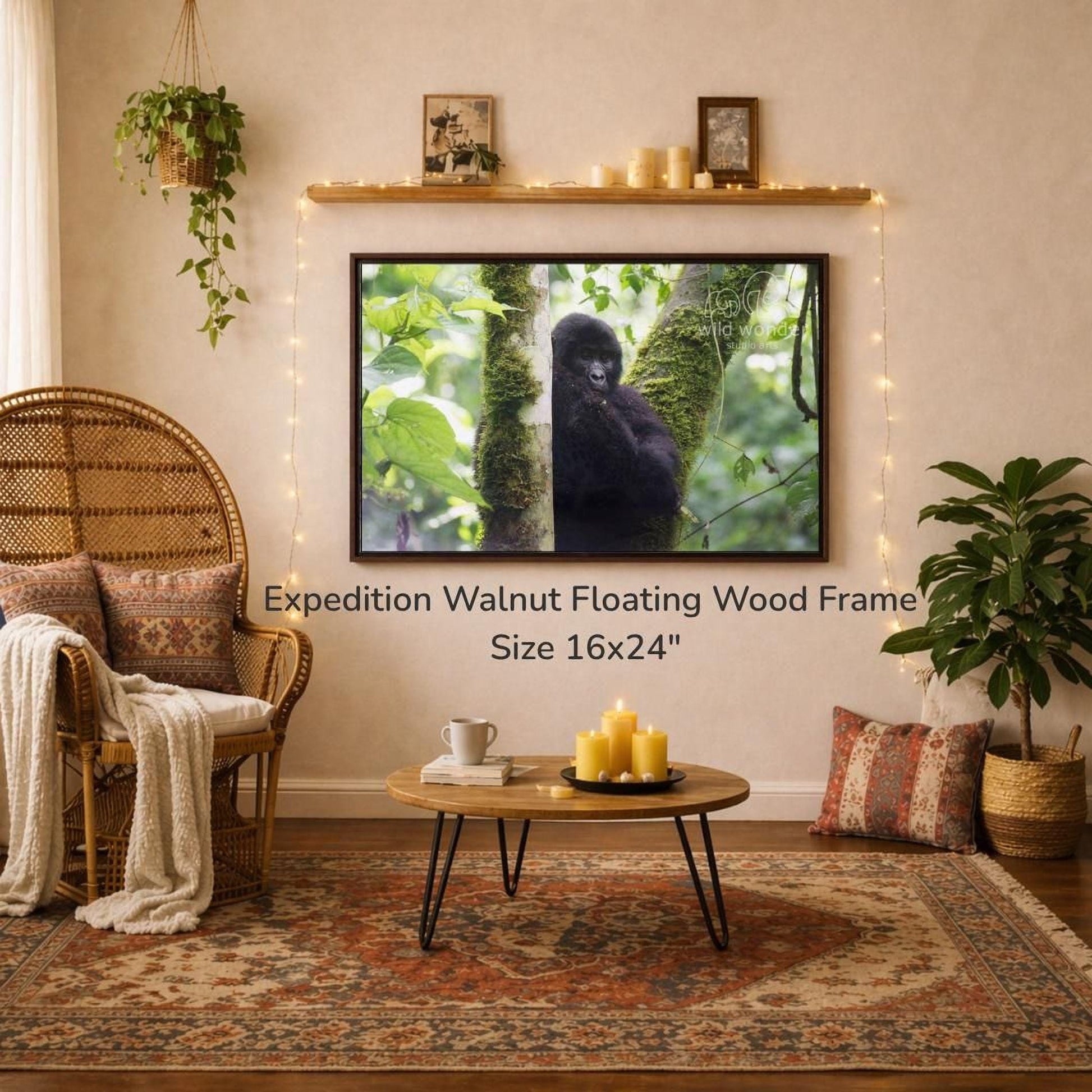 a cozy living room with a large 16x24" walnut floating wood frame hanging on the wall, a coffee table in front of it, and a wicker chair. The room is decorated with potted plants, candles, and a rug, creating a warm and inviting atmosphere.