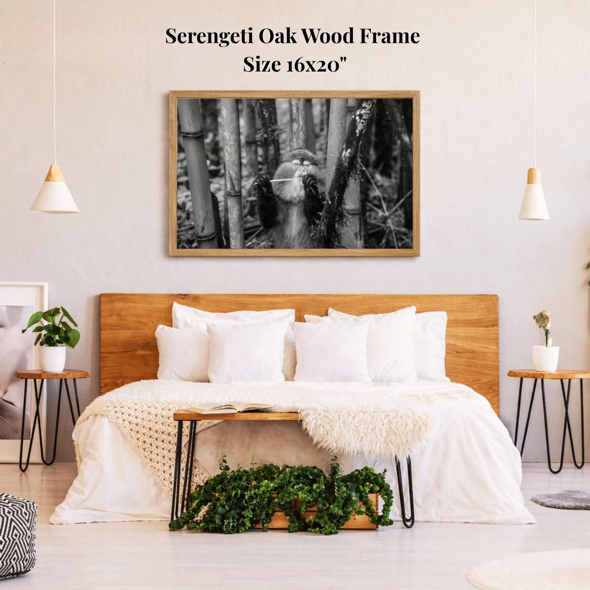 a serene bedroom setting with a large wooden headboard, a cozy bed with white bedding, and a framed black and white photograph of a bamboo forest hanging on the wall above the bed.