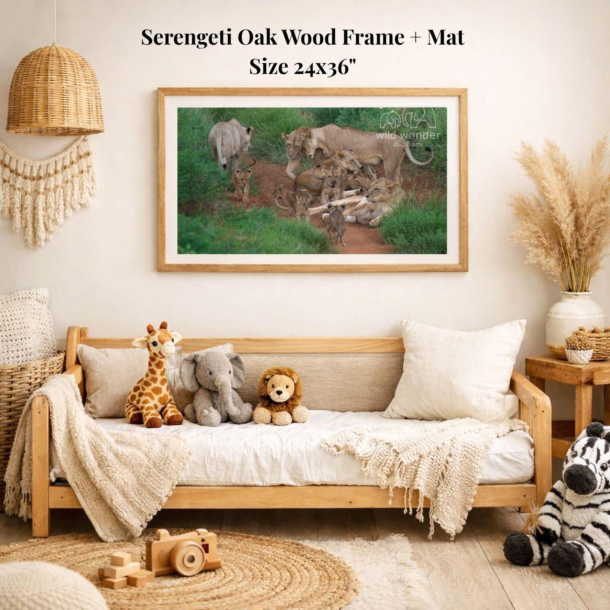 a serene indoor setting with a wooden frame and mat hanging on the wall, displaying a photograph of a group of animals in a natural environment. The frame is surrounded by various stuffed animals, including a giraffe, elephant, lion, and zebra, creating a cozy and playful atmosphere.