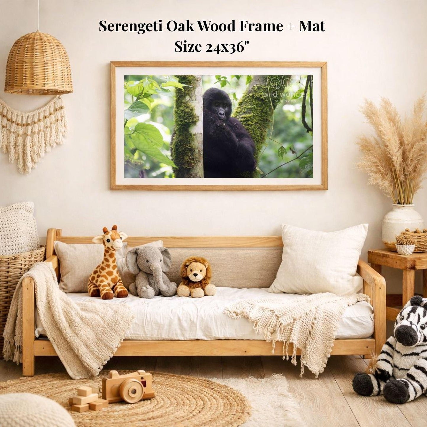 a serene indoor setting with a wooden frame and mat hanging on a wall, displaying a photograph of a gorilla in a lush green forest. The room is decorated with various stuffed animals, including a giraffe, elephant, lion, and zebra, arranged on a couch and a rug.