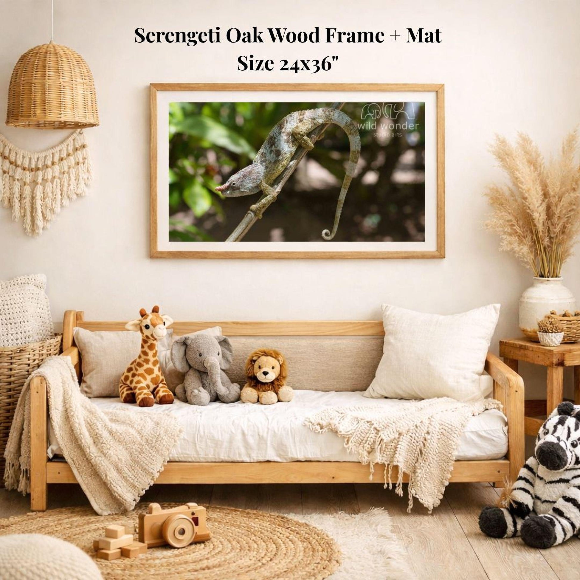 a serene indoor setting with a wooden frame and mat hanging on a wall, displaying a photograph of a chameleon on a branch. The frame is surrounded by various stuffed animals, including a giraffe, elephant, lion, and zebra, creating a cozy and playful atmosphere.
