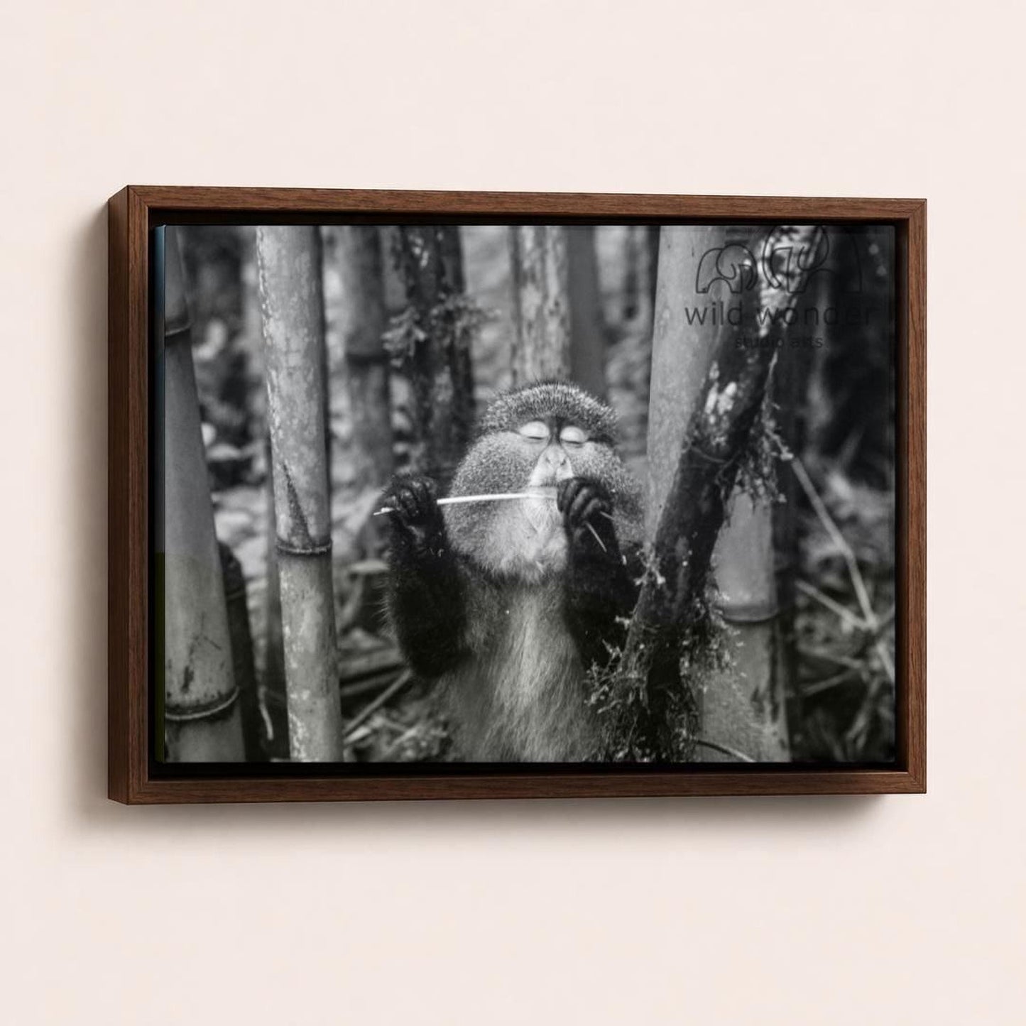 A monkey is standing in a forest, holding a stick in its hands.