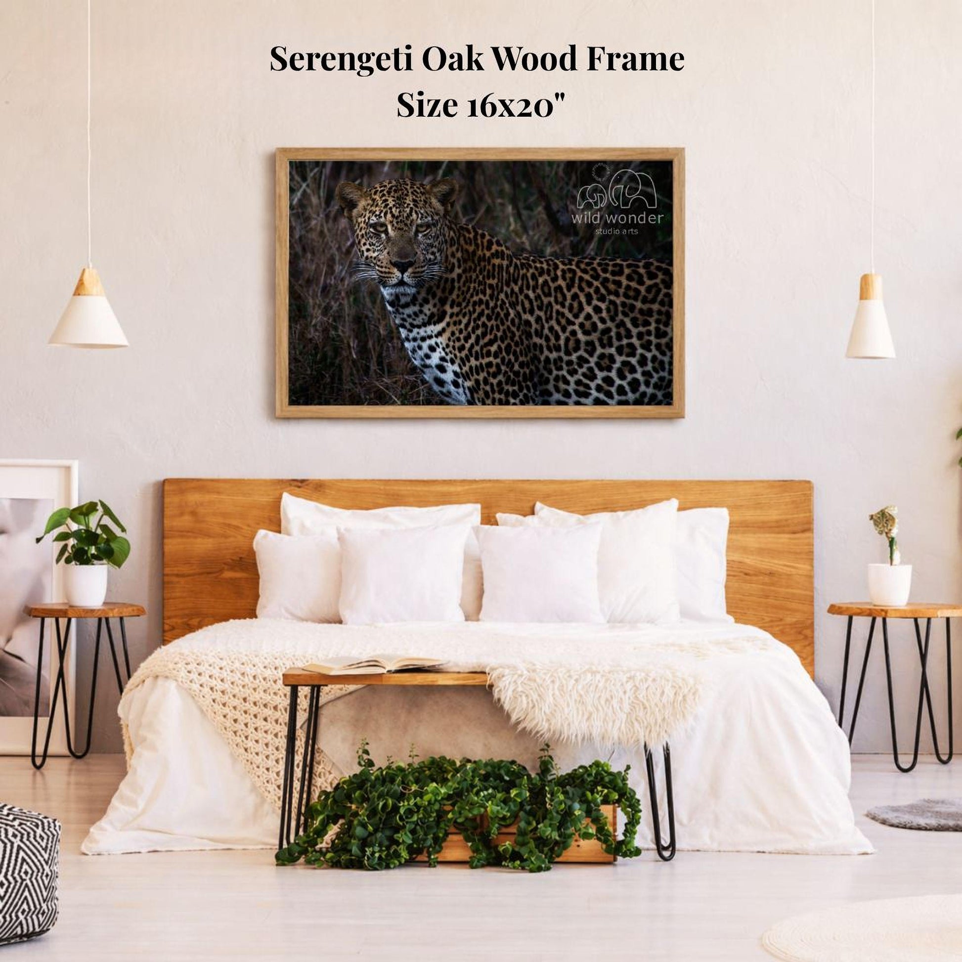 a bedroom with a large framed picture of a leopard on the wall above a bed with white bedding.