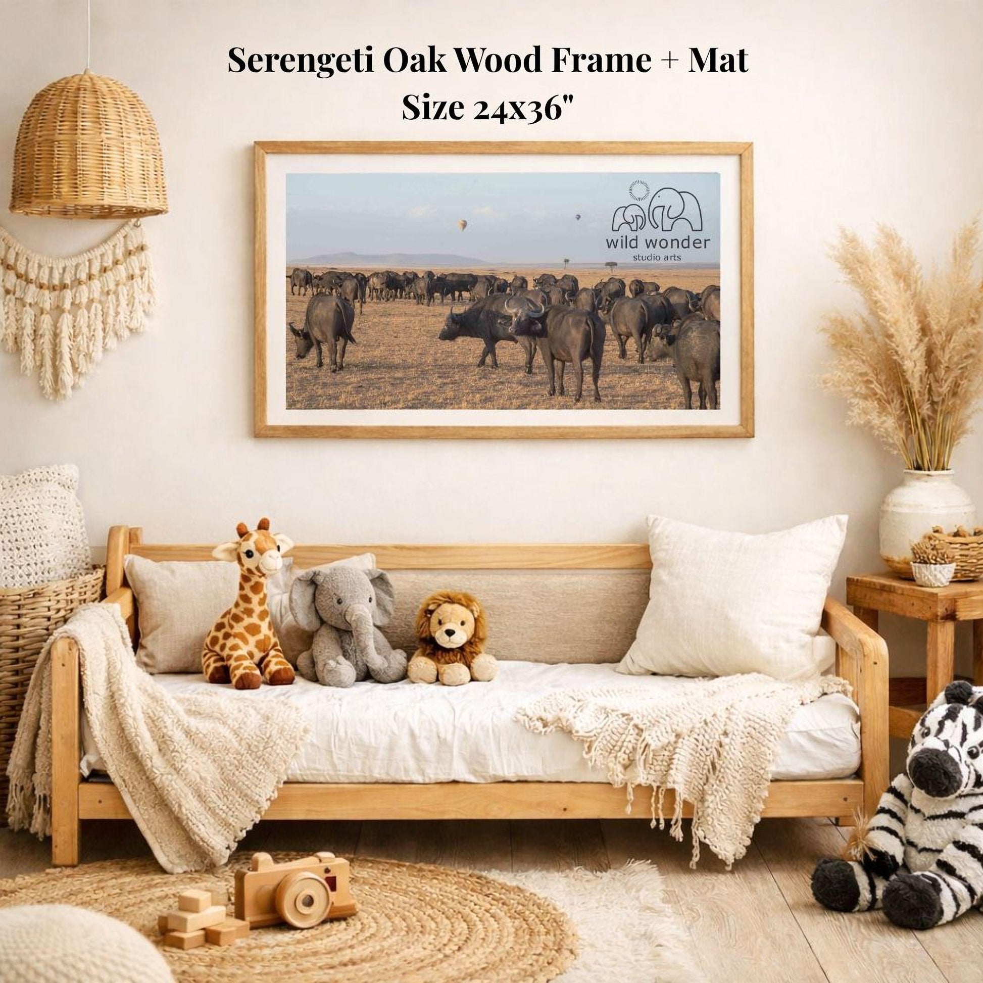 a serene indoor setting with a wooden frame and mat hanging on the wall, depicting a herd of wild animals in a field. The frame is surrounded by various stuffed animals, including a giraffe, elephant, lion, and zebra, creating a cozy and playful atmosphere.