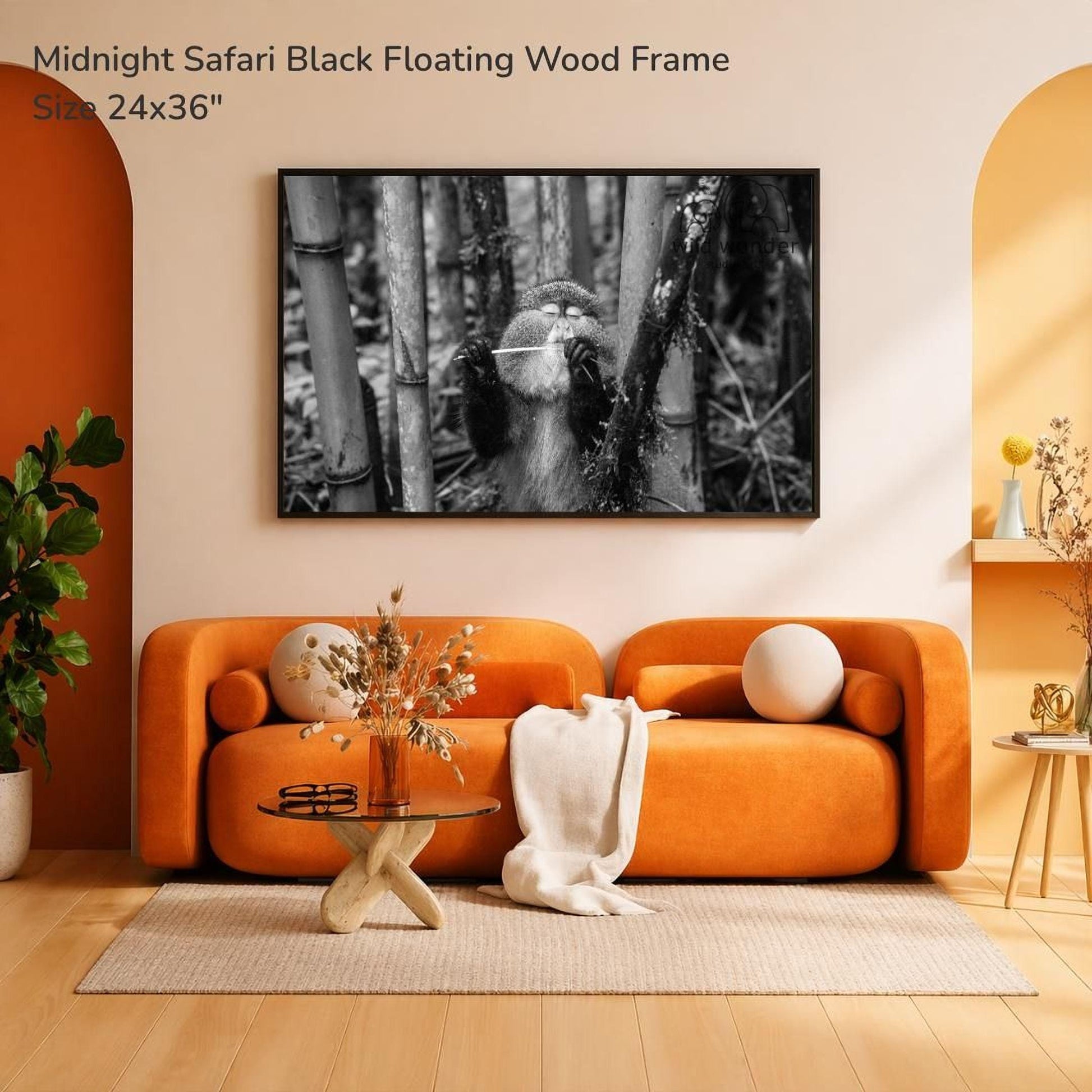a modern living room with an orange sofa, a glass coffee table, and a framed photograph of a black and white image of a monkey hanging on a wall.